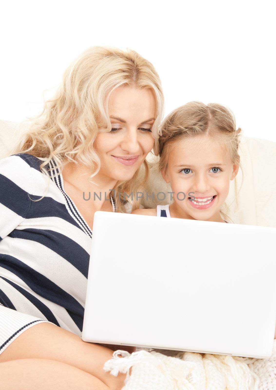 bright picture of happy mother and child with laptop computer (focus on woman)