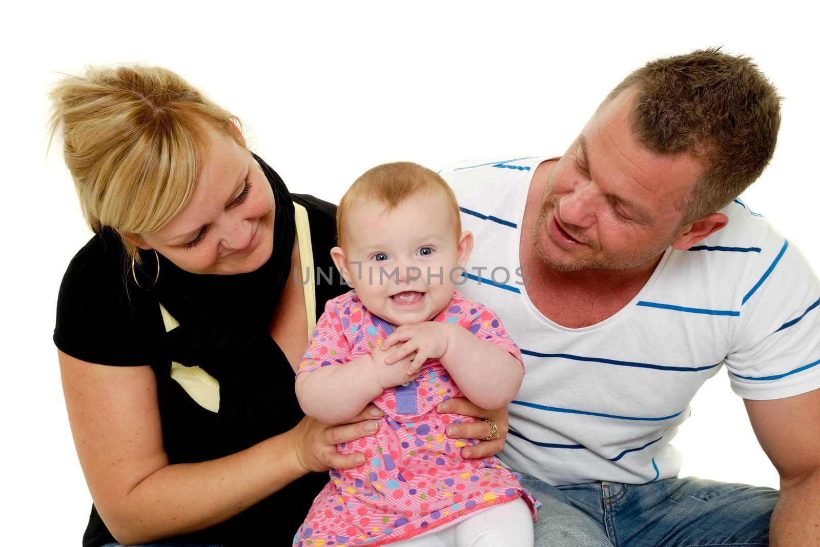 Happy family. Mother and father are looking at their sweet smiling 4 month old baby.