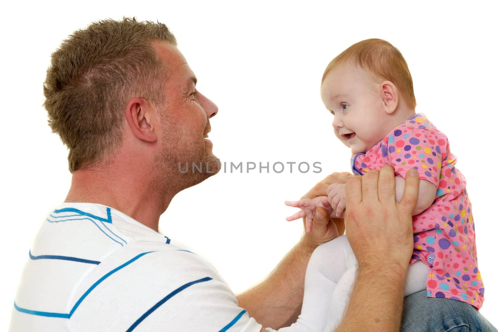 Baby and father are playing. They are both smiling and are very happy together.  The baby 3 month old. Isolated on a white background.