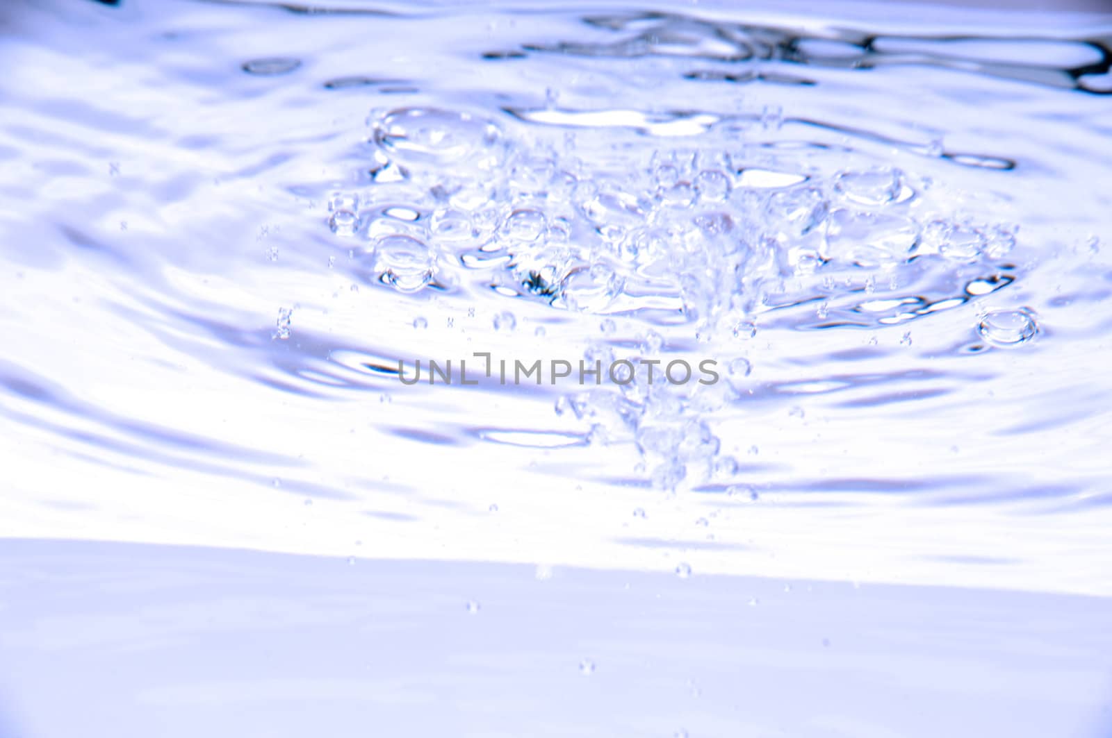 Blue water with air bubbles in the water line. Focus on the water line.