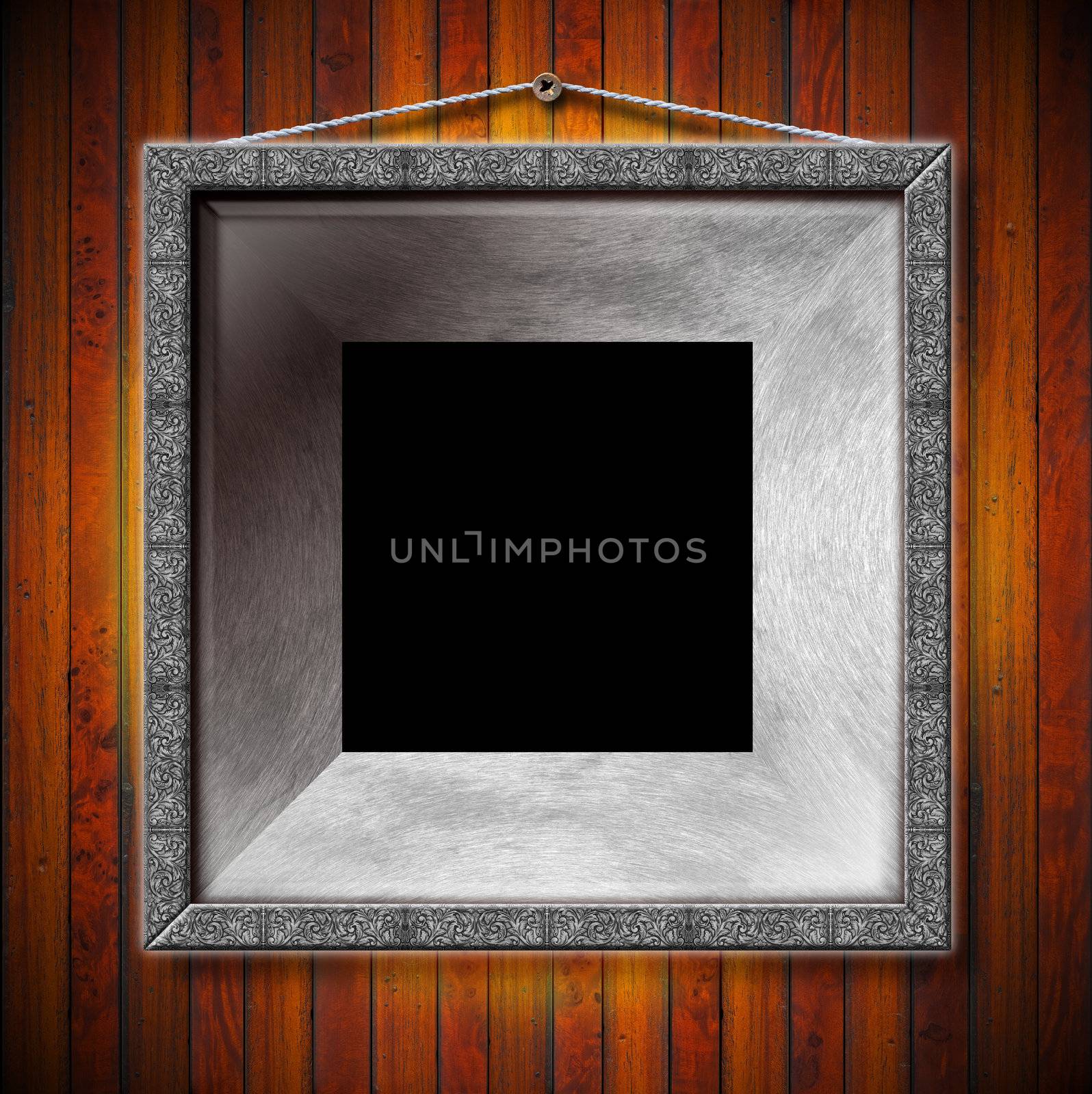 Empty metallic frames on a old dark wooden wall

