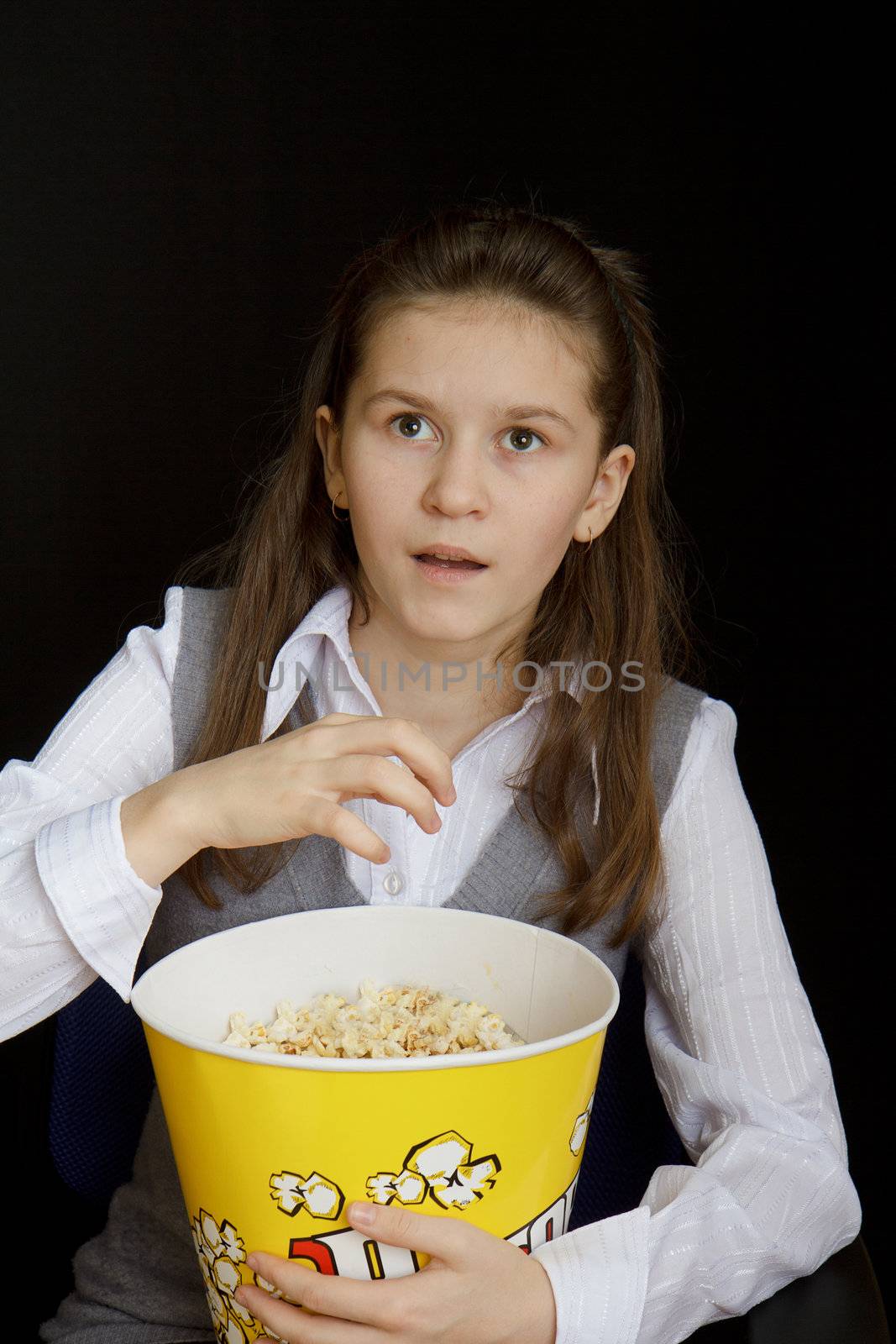 emotional girl with popcorn on a black background