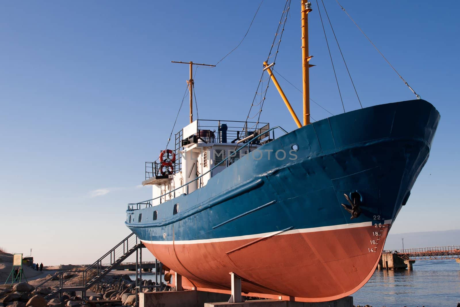 Old fishing boat docked on pedestal