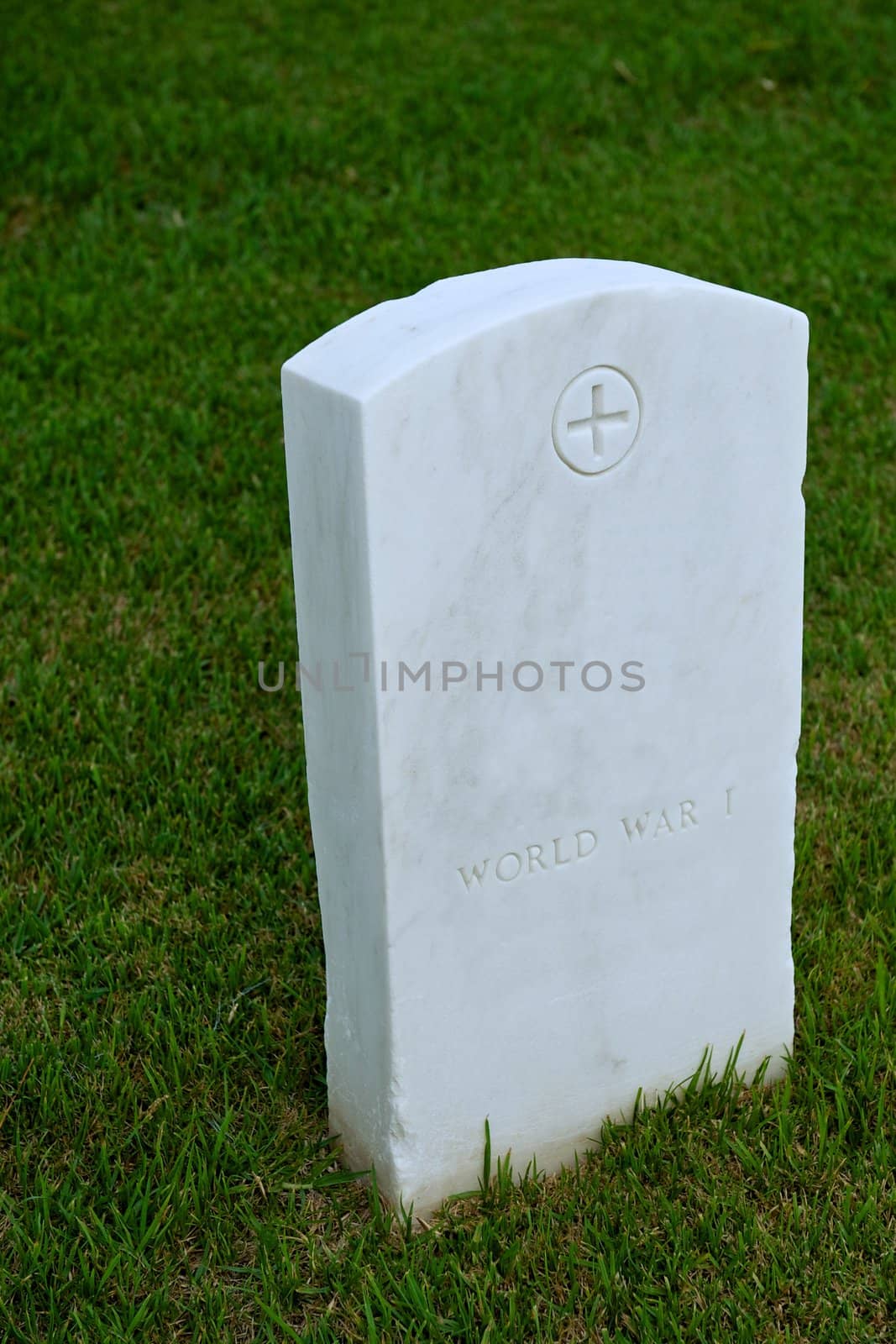 White marble headstone or gravestone in a green military cemetery