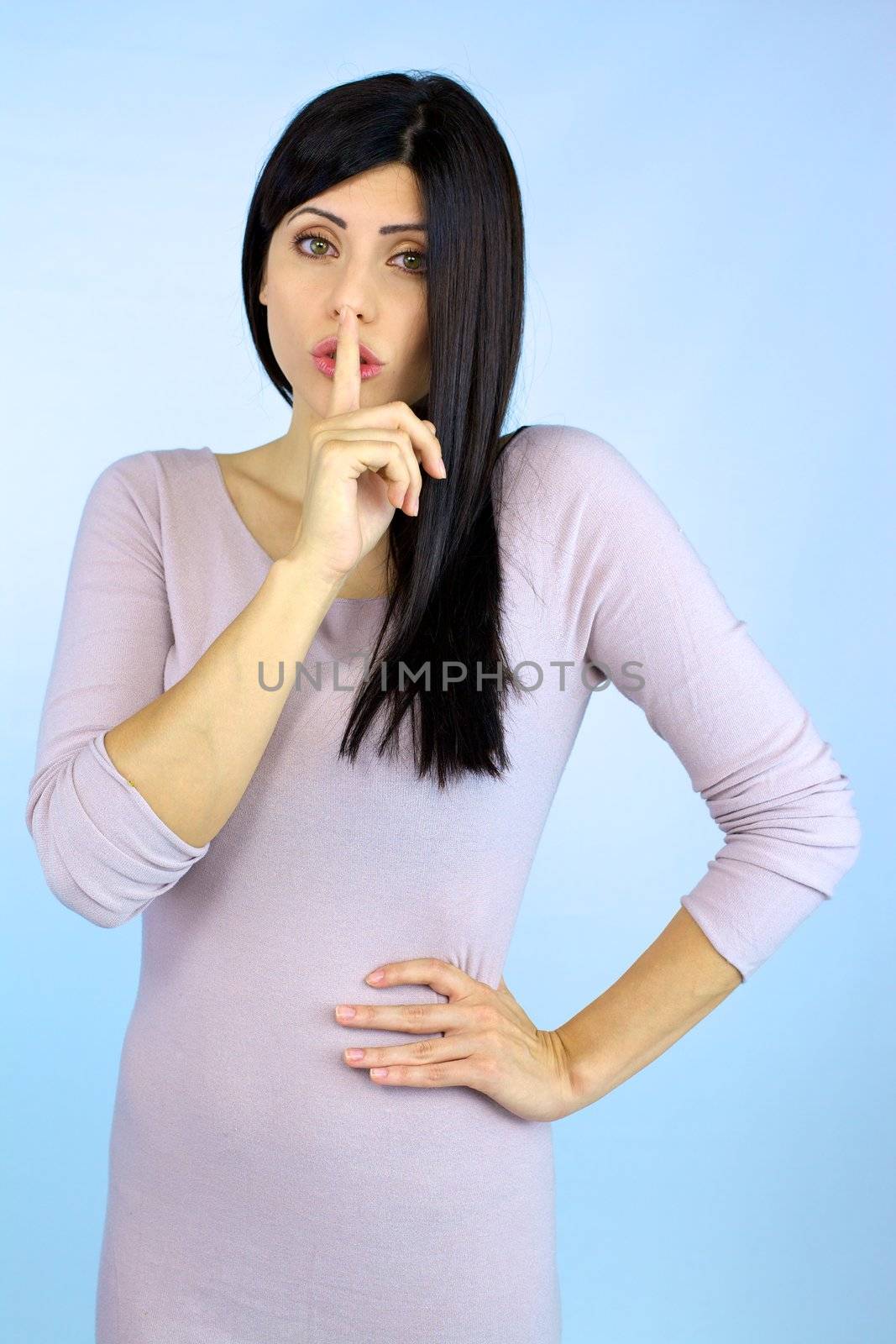 Beautiful young woman making funny silence sign by fmarsicano
