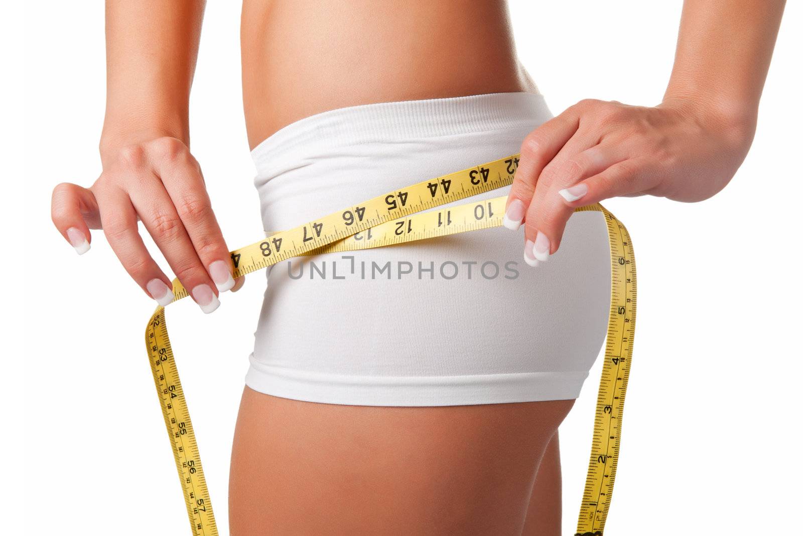 Woman measuring her waist with a yellow measuring tape