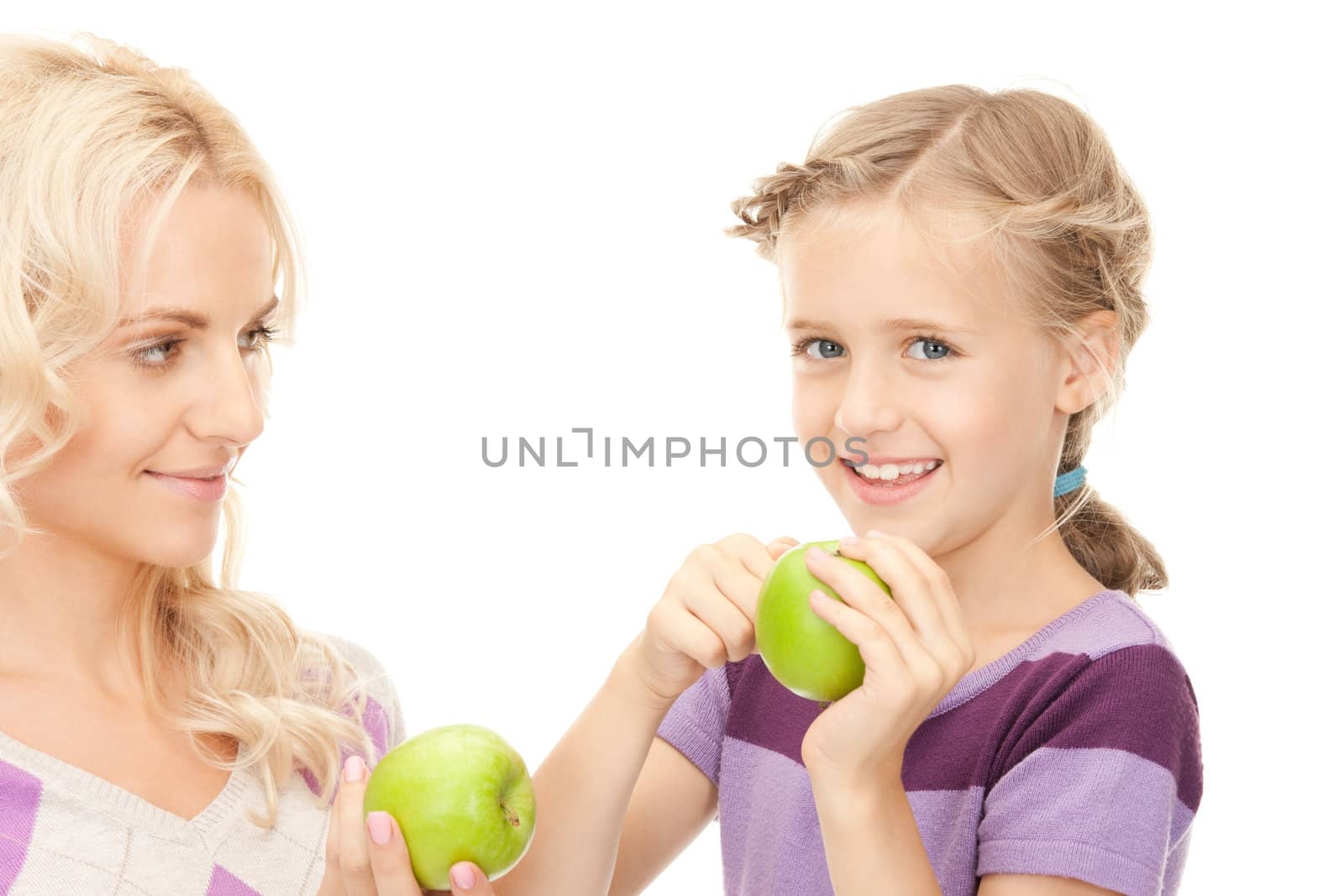 picture of mother and little girl with green apple
