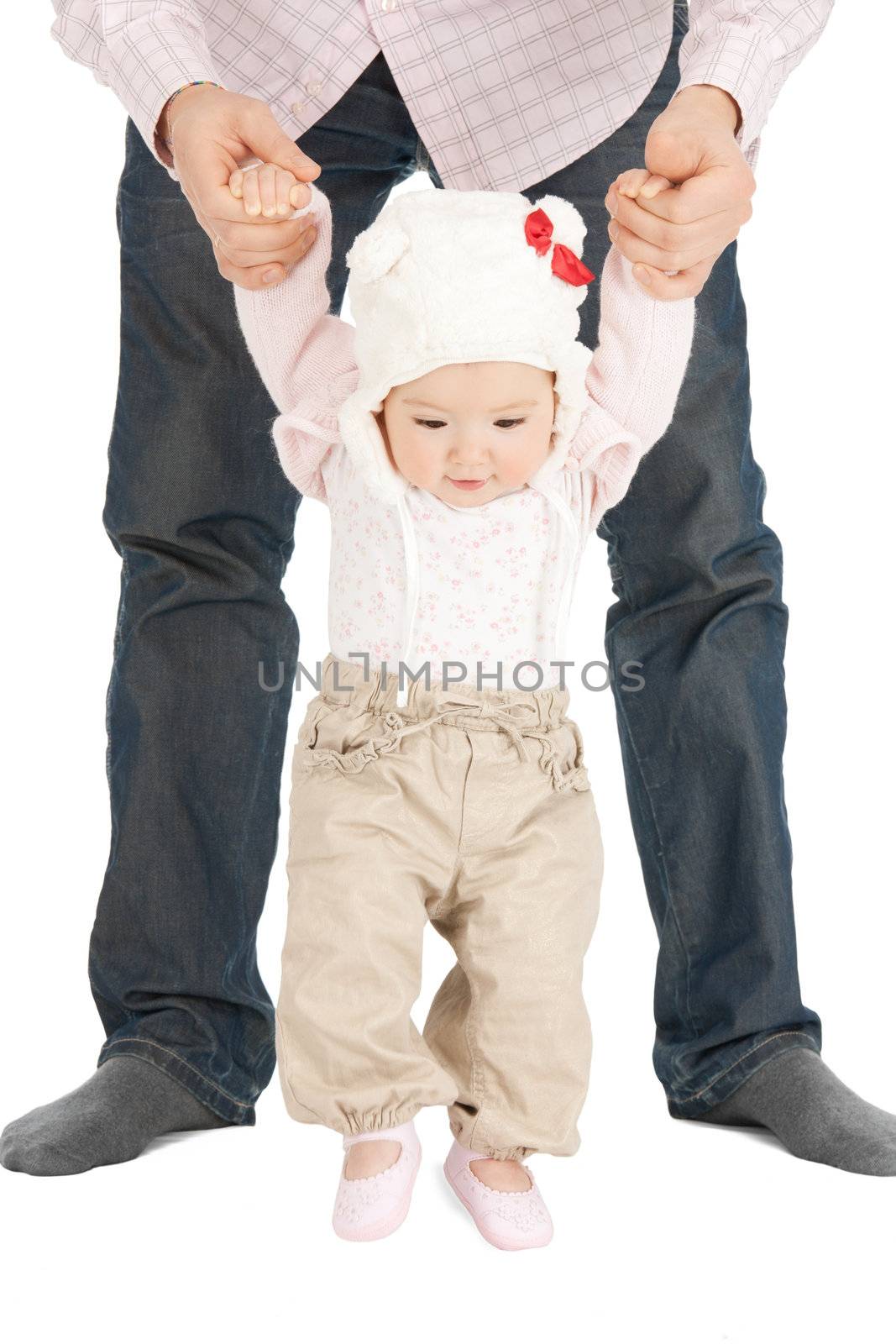 picture of baby making first steps with father help