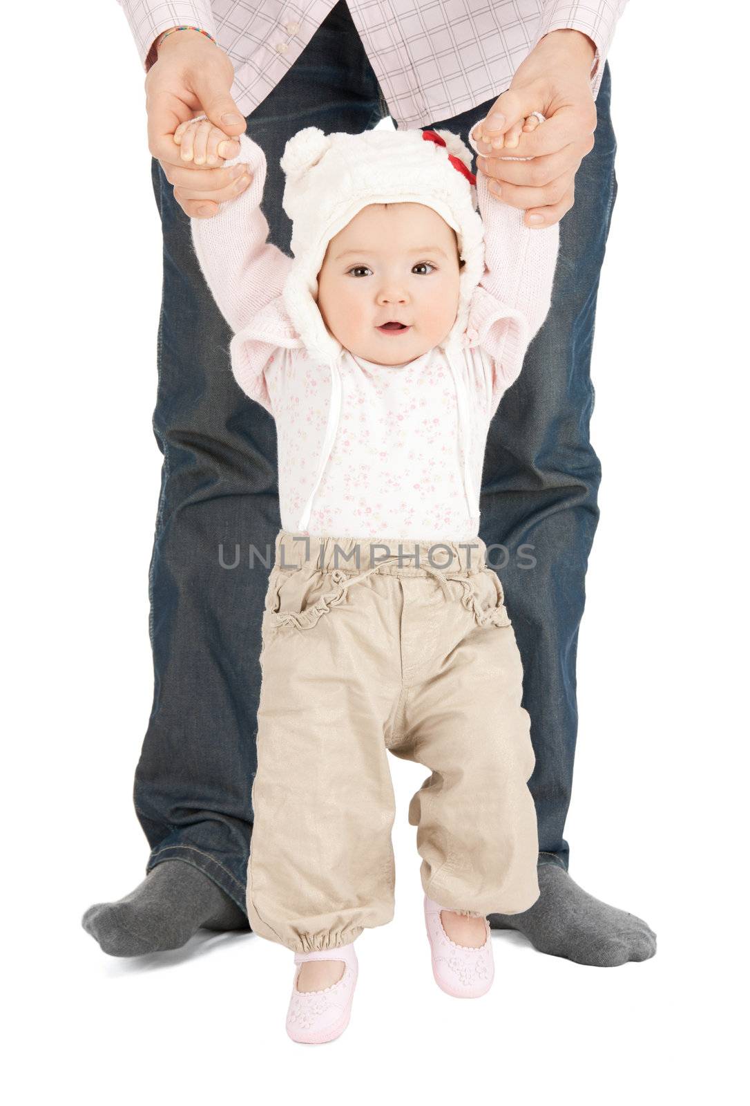 picture of baby making first steps with father help