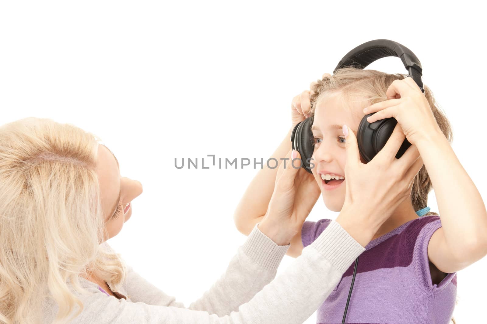 mother and little girl with headphones by dolgachov