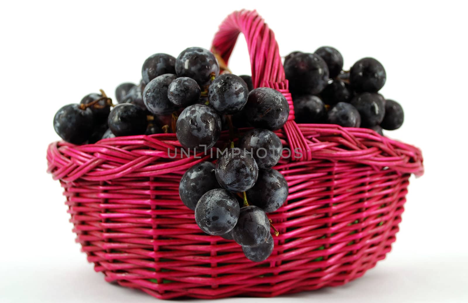 Basket with grapes on white background