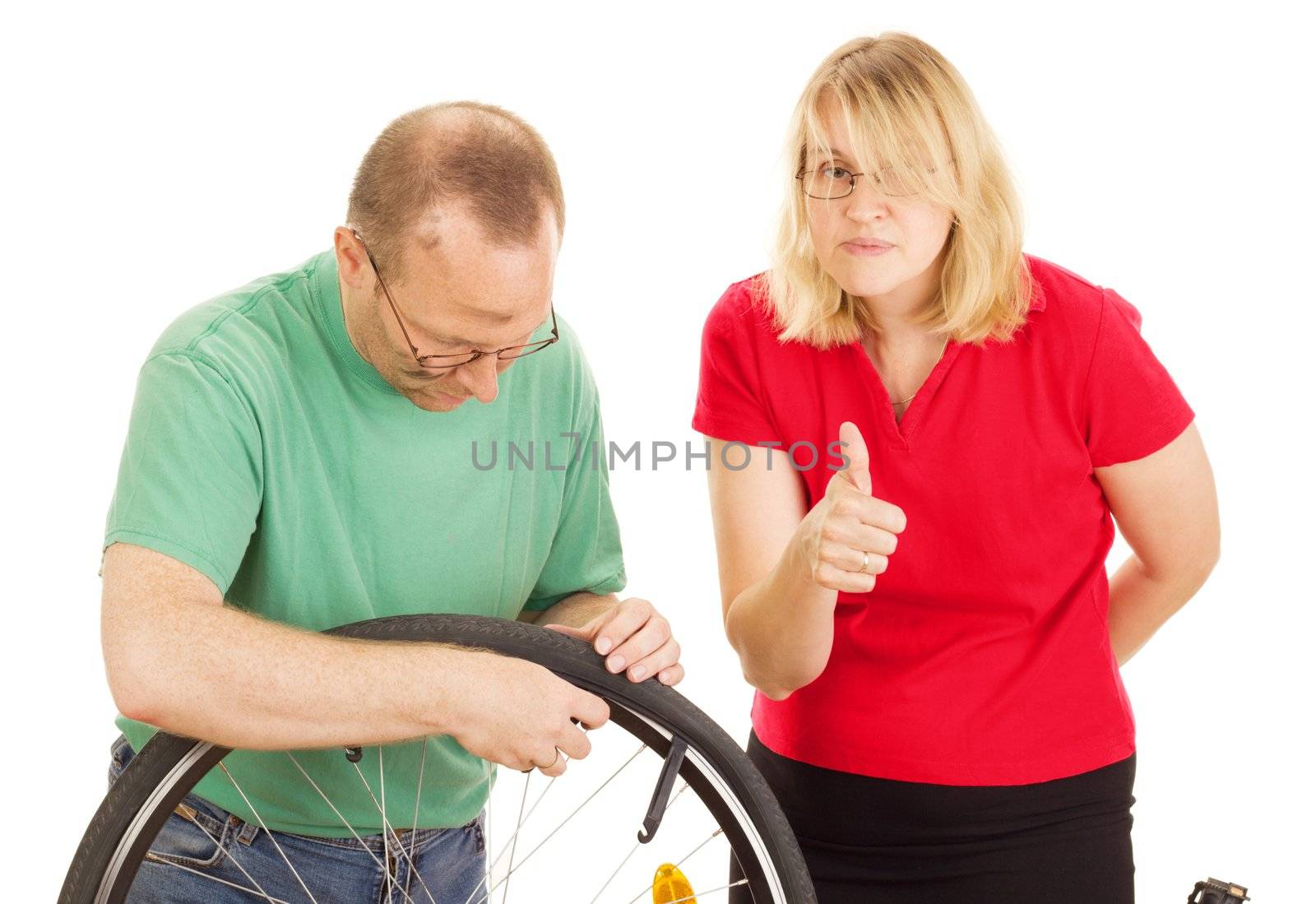 A mechanic repairs the wheel of a bicycle