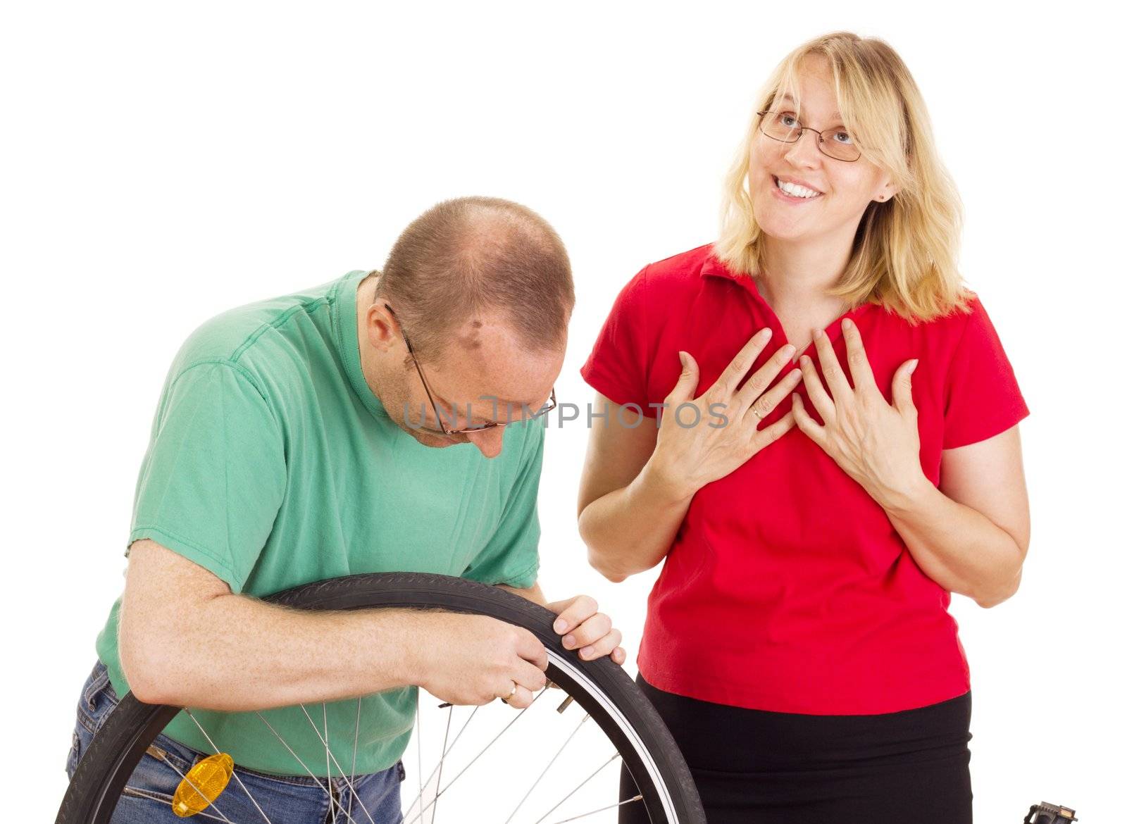 A mechanic repairs the wheel of a bicycle