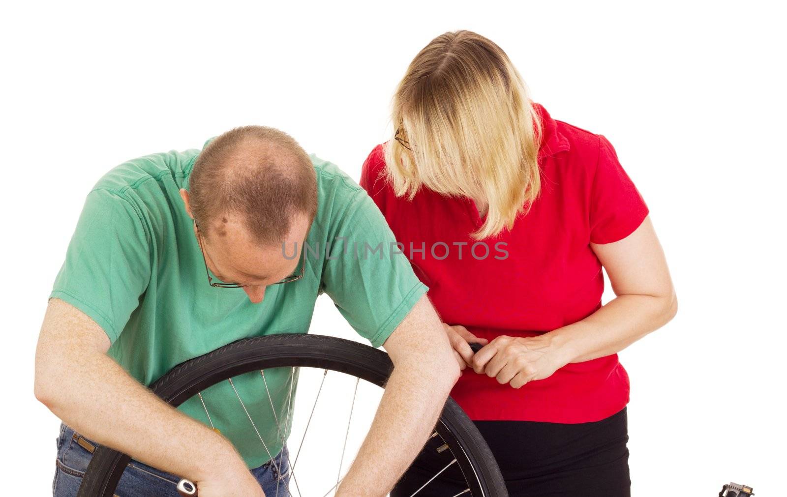 A mechanic repairs the wheel of a bicycle