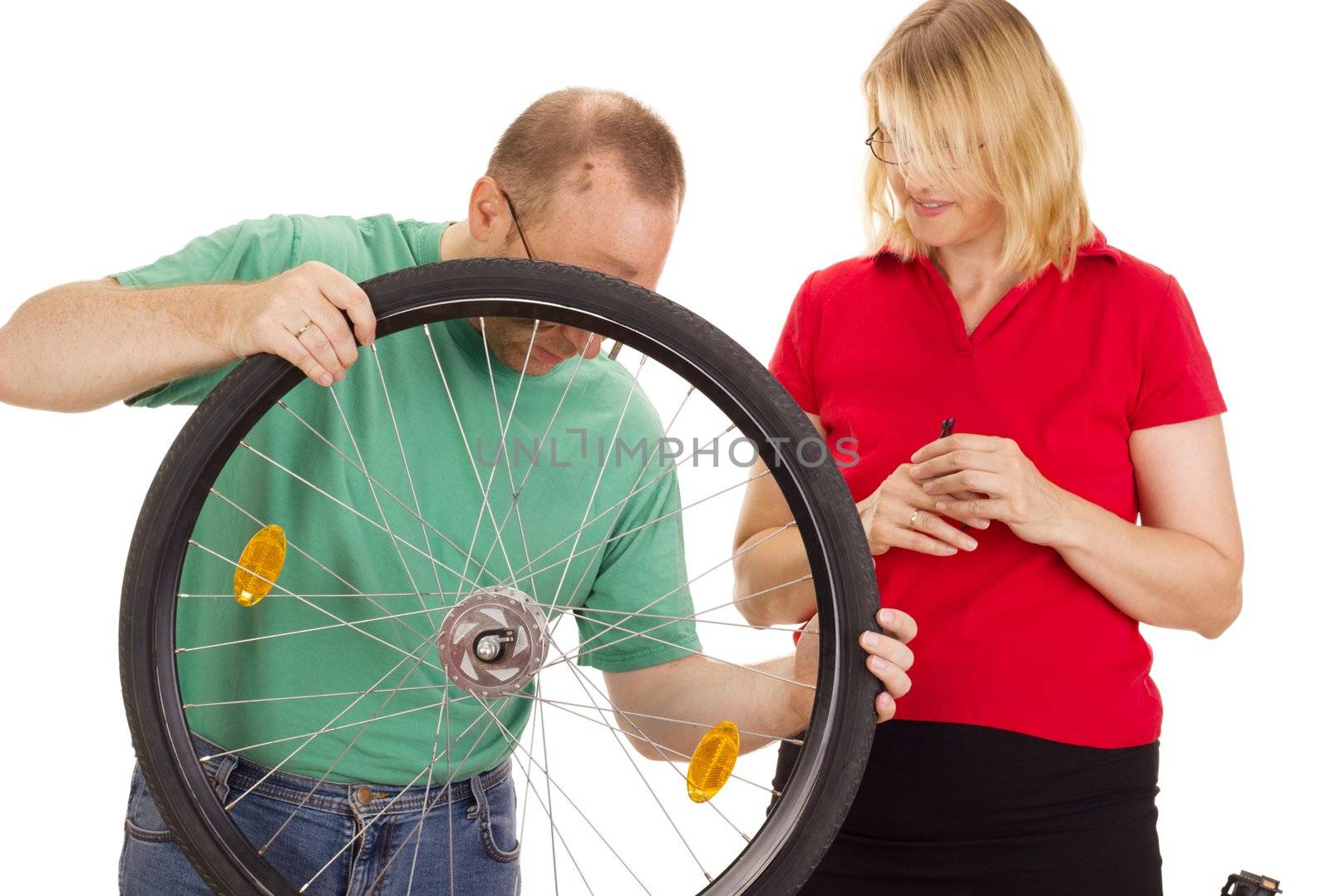 A mechanic repairs the wheel of a bicycle