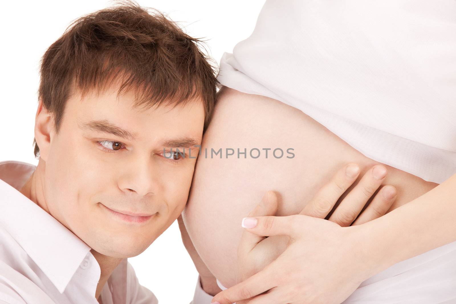 bright closeup picture of male face and pregnant woman belly