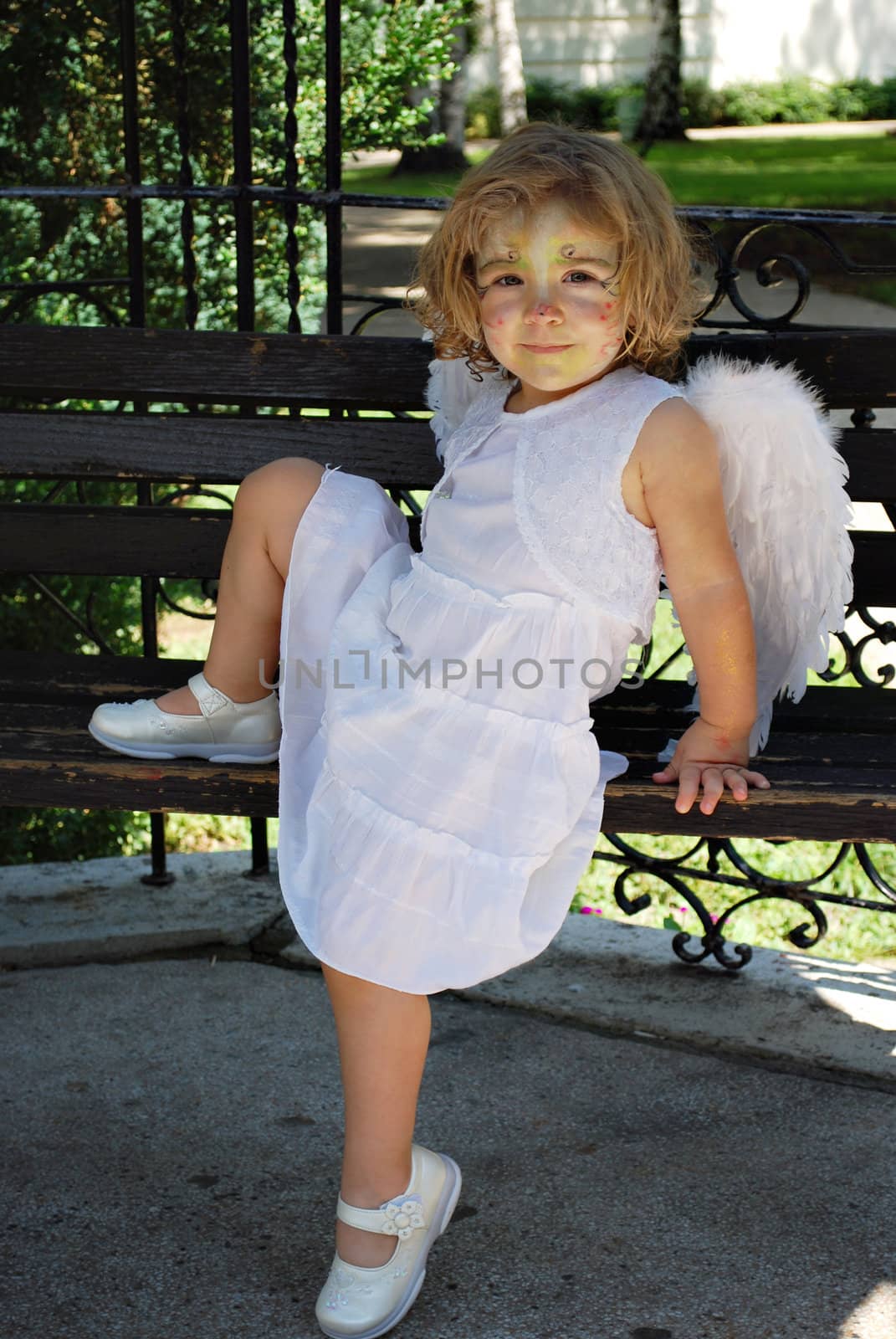 Little angel child in white dress