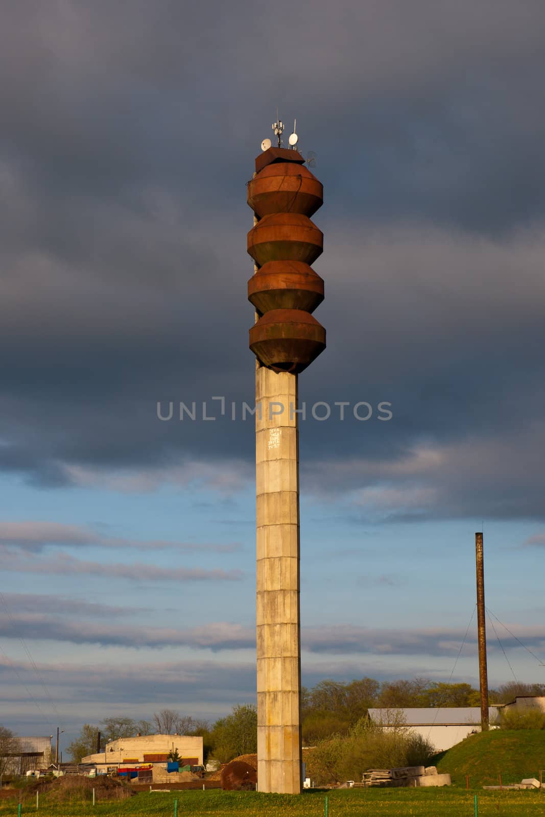 Old big rusty water tower in contryside