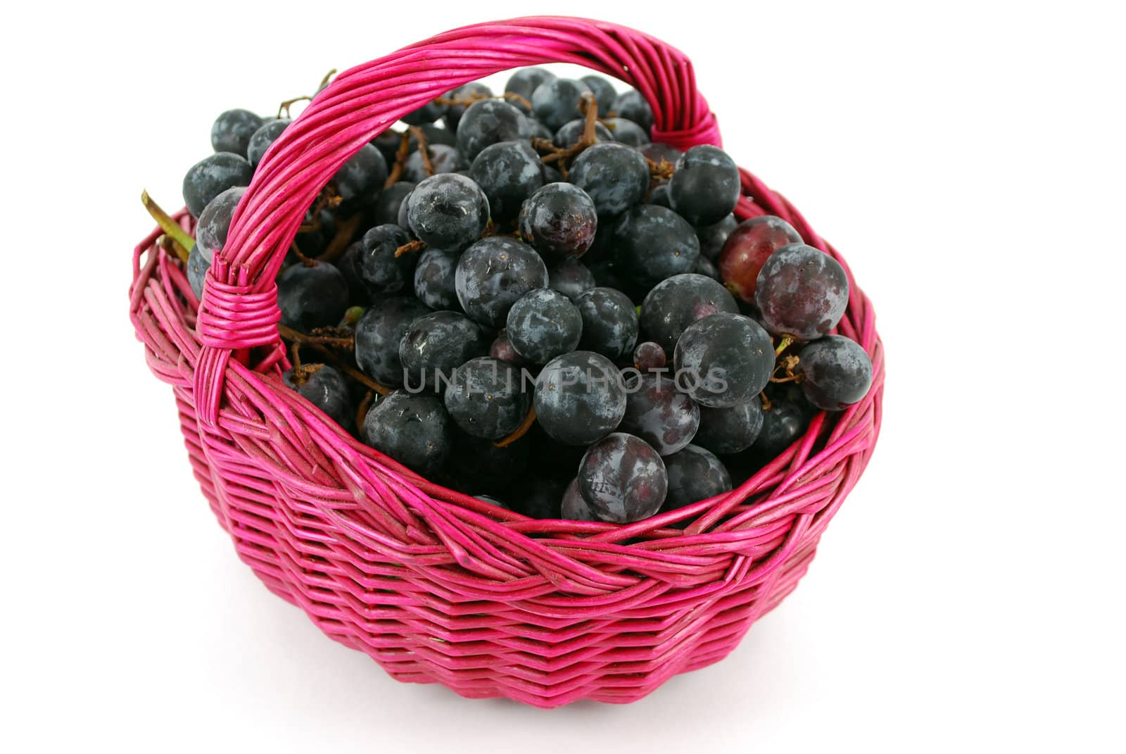 Basket with grapes isolated on white