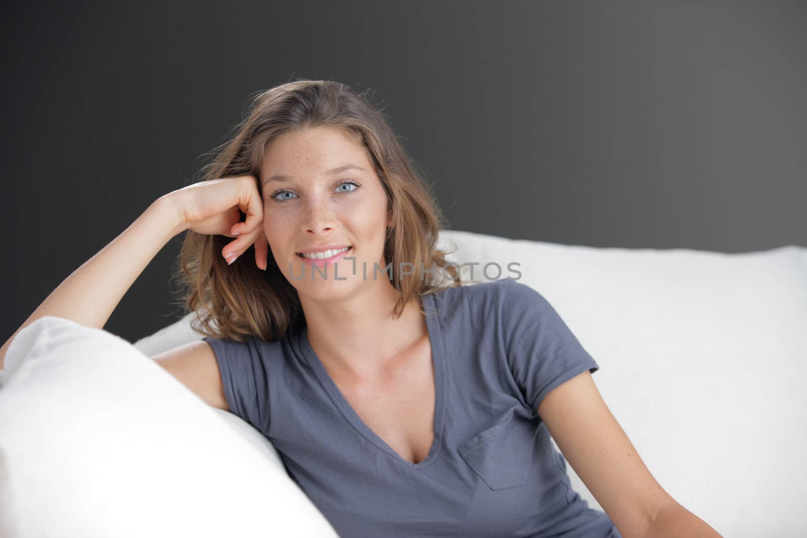 Portrait of beautiful young woman relaxing on couch 