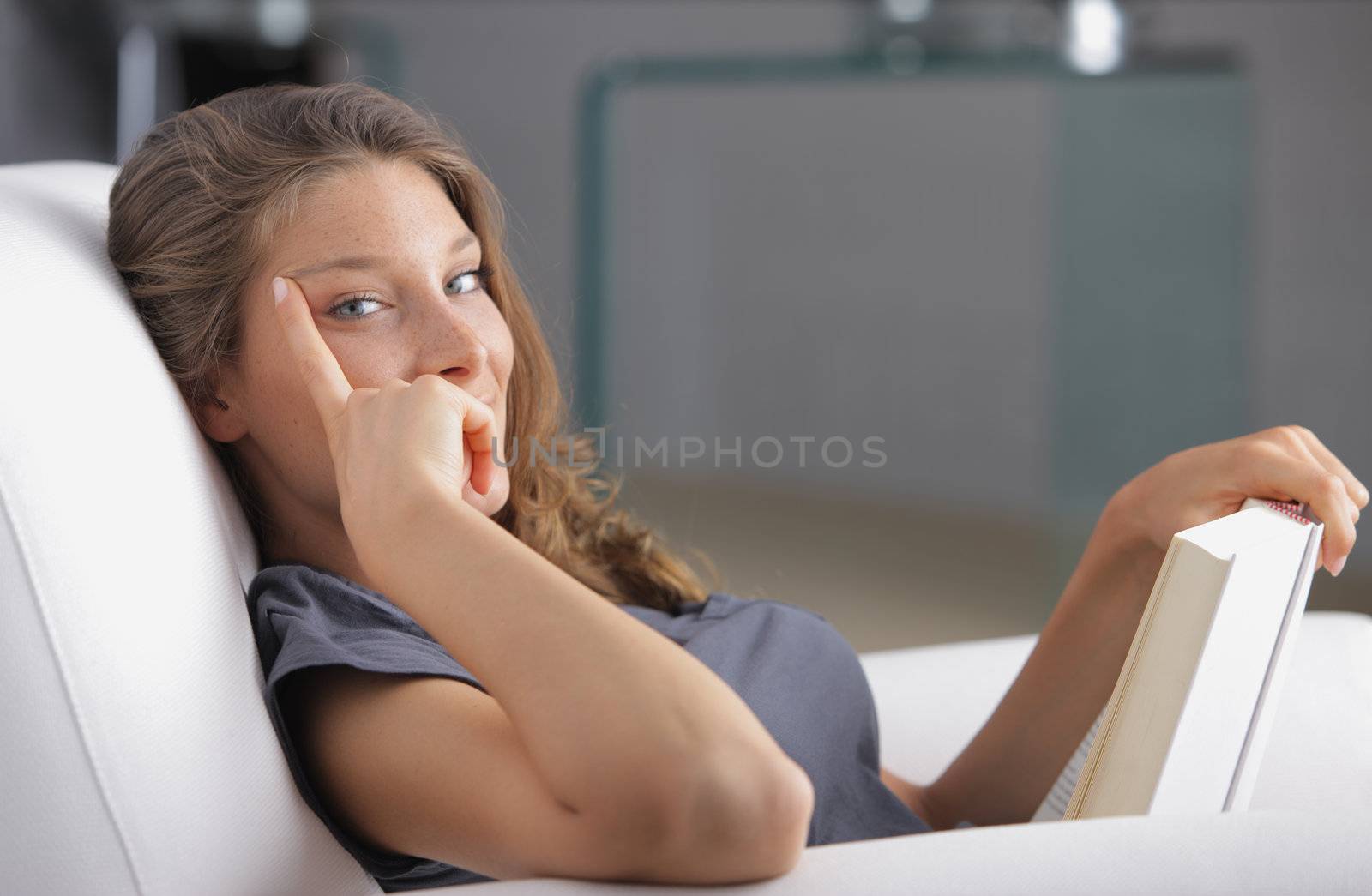 Portrait of a young beautiful woman reading a book