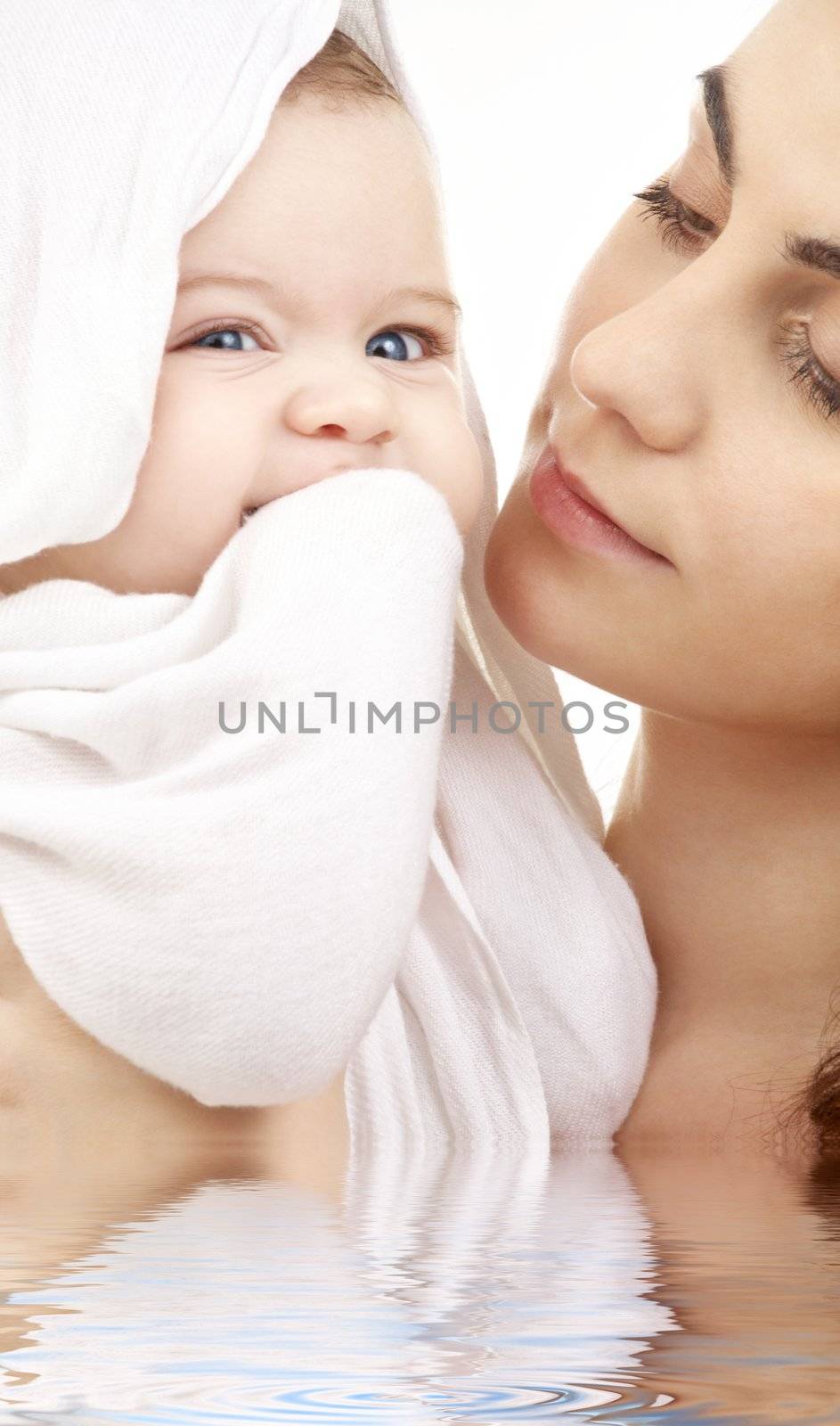 picture of happy mother with baby in water (focus on mother)
