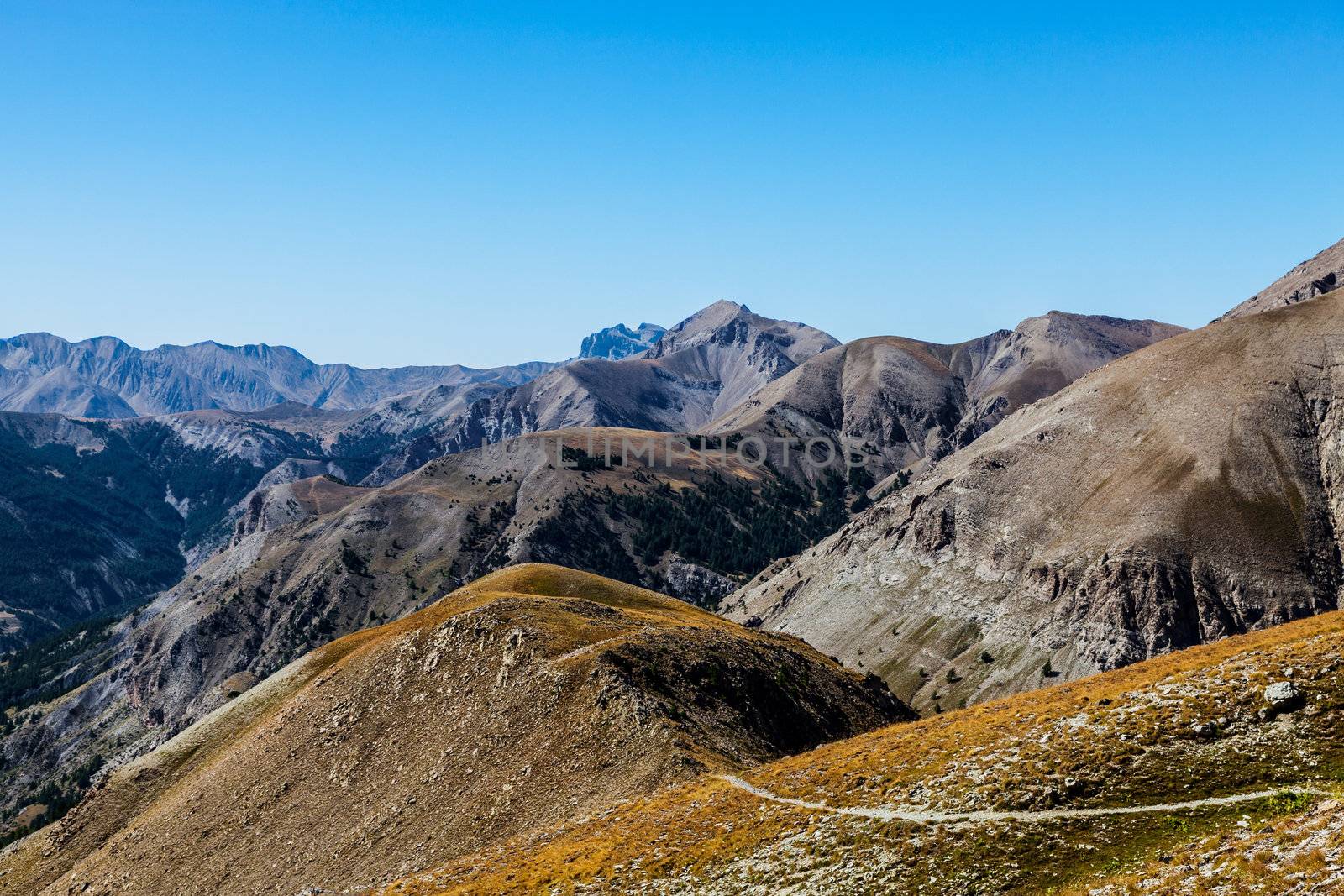 Beautiful landscape at high altitude in the Southern Franch Alps with a small footpath in the bottom of the image.