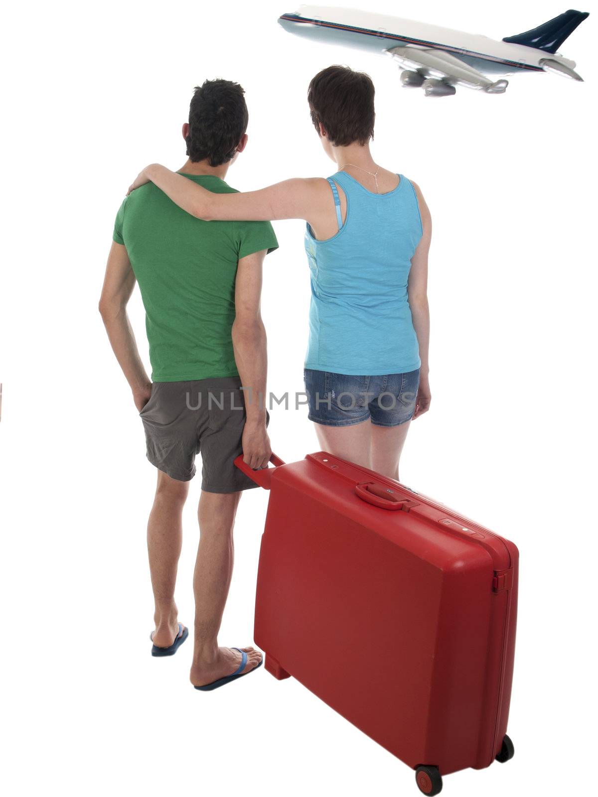 young couple going on vacation with suitcase on a passenger plane by kees59