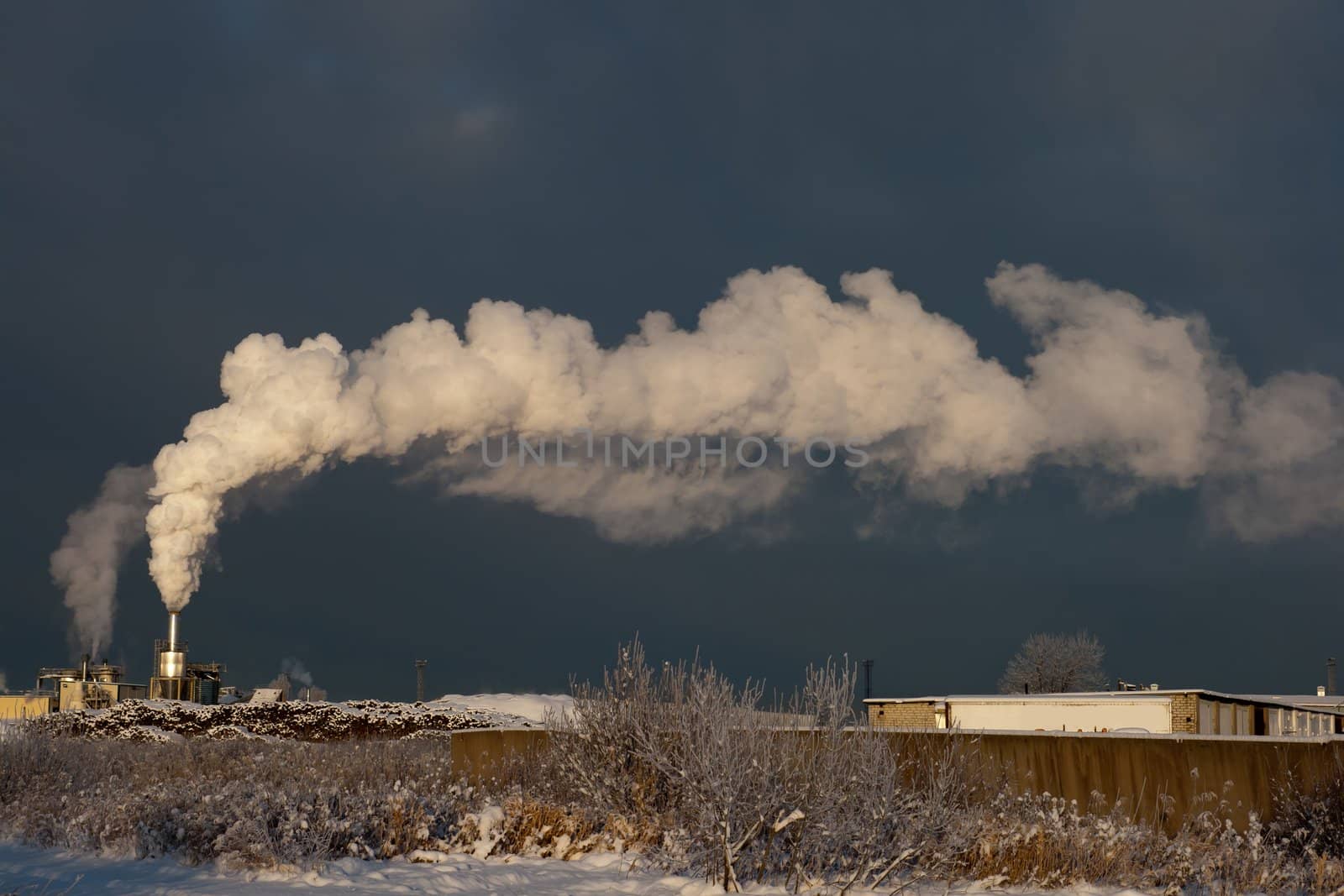 Factory smoke in the dark winter sky