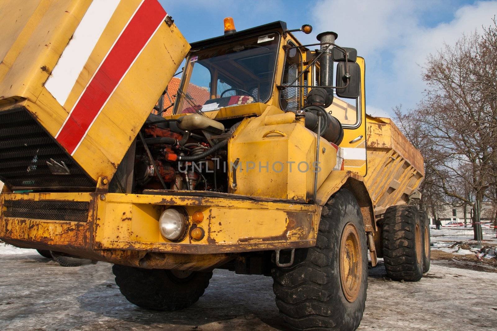 Big broken yellow dumper in a construction site