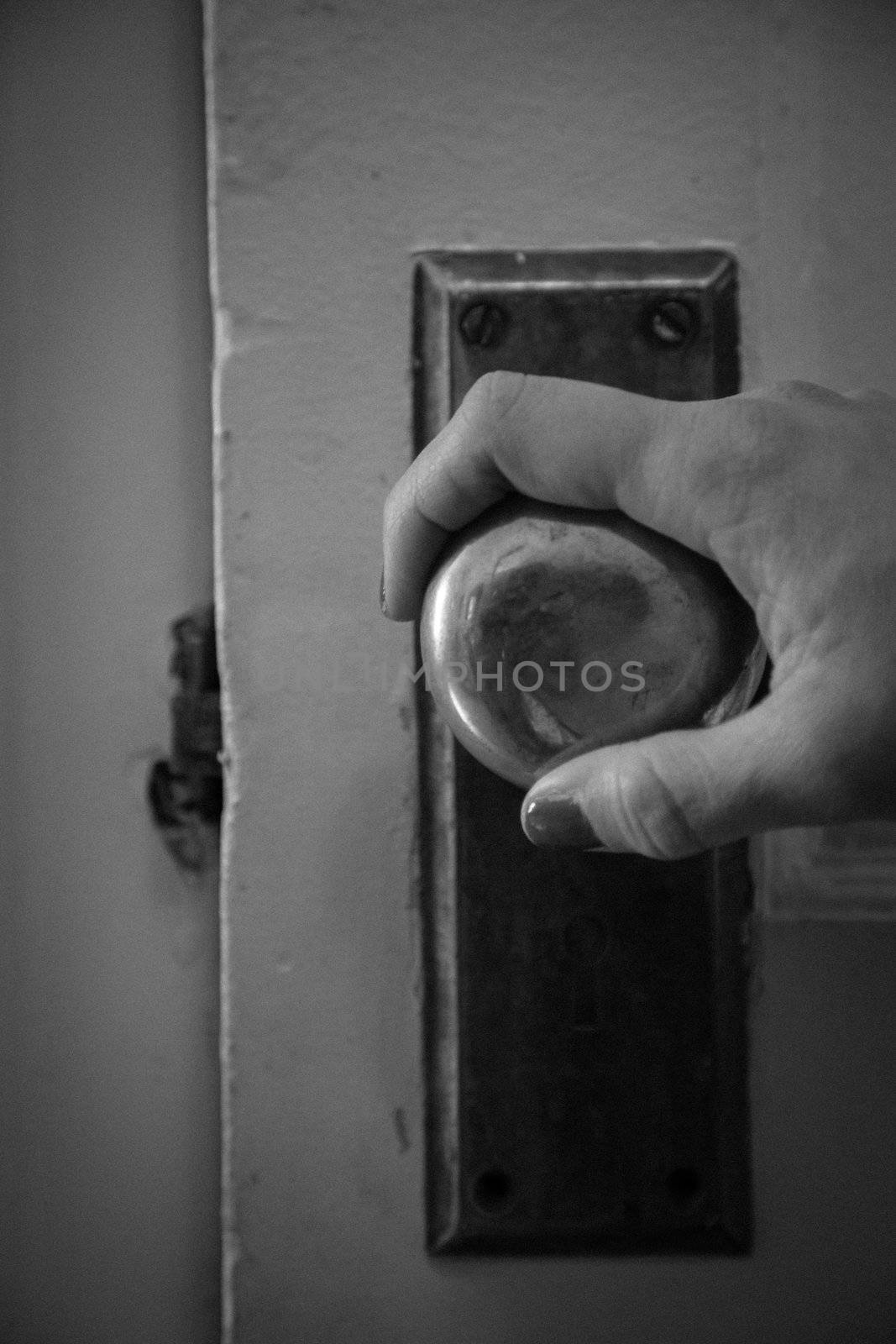 Hand holding a vintage door handle