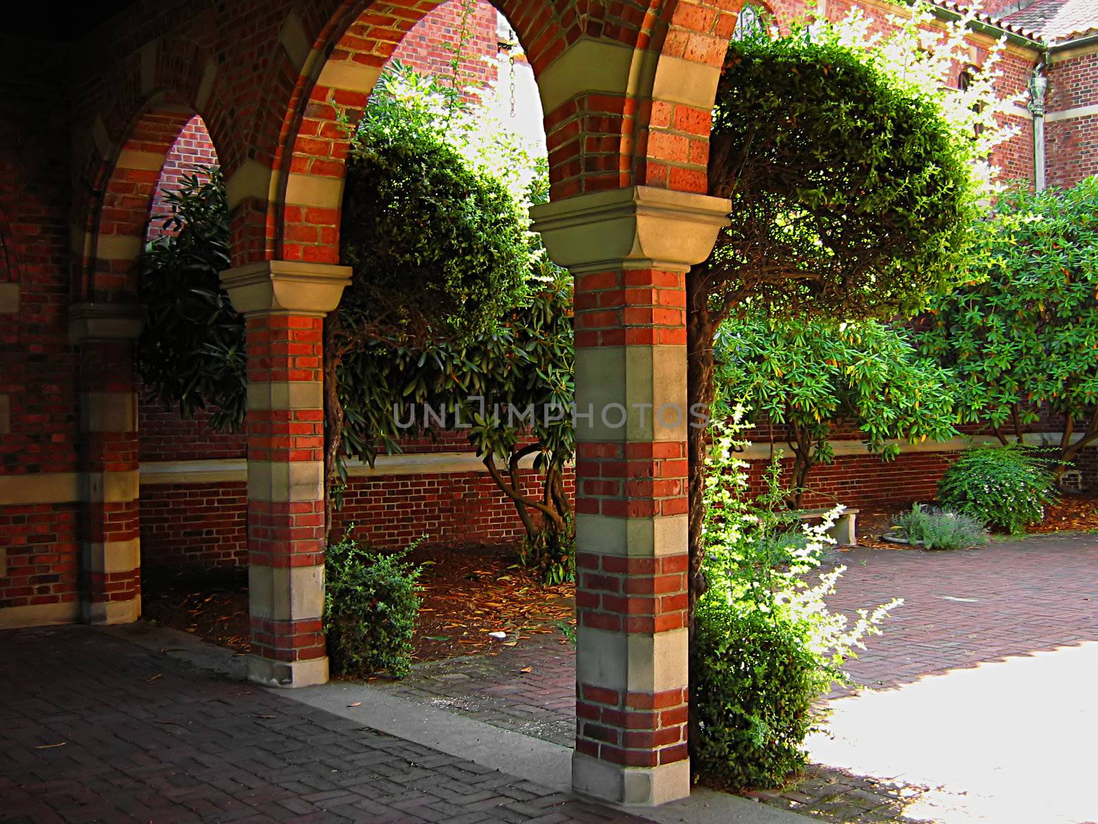 A photograph of an arched walkway of a church detailing its architectural design.