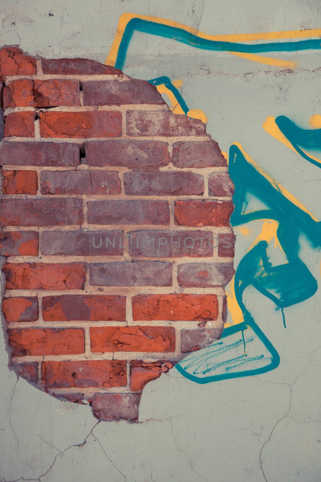 Old brick and concret wall with graffiti