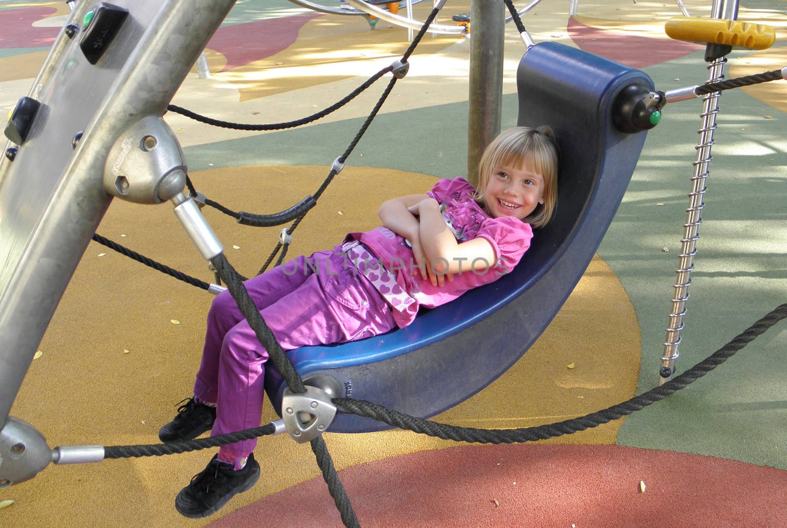 Photo of a child what playing on a playground.