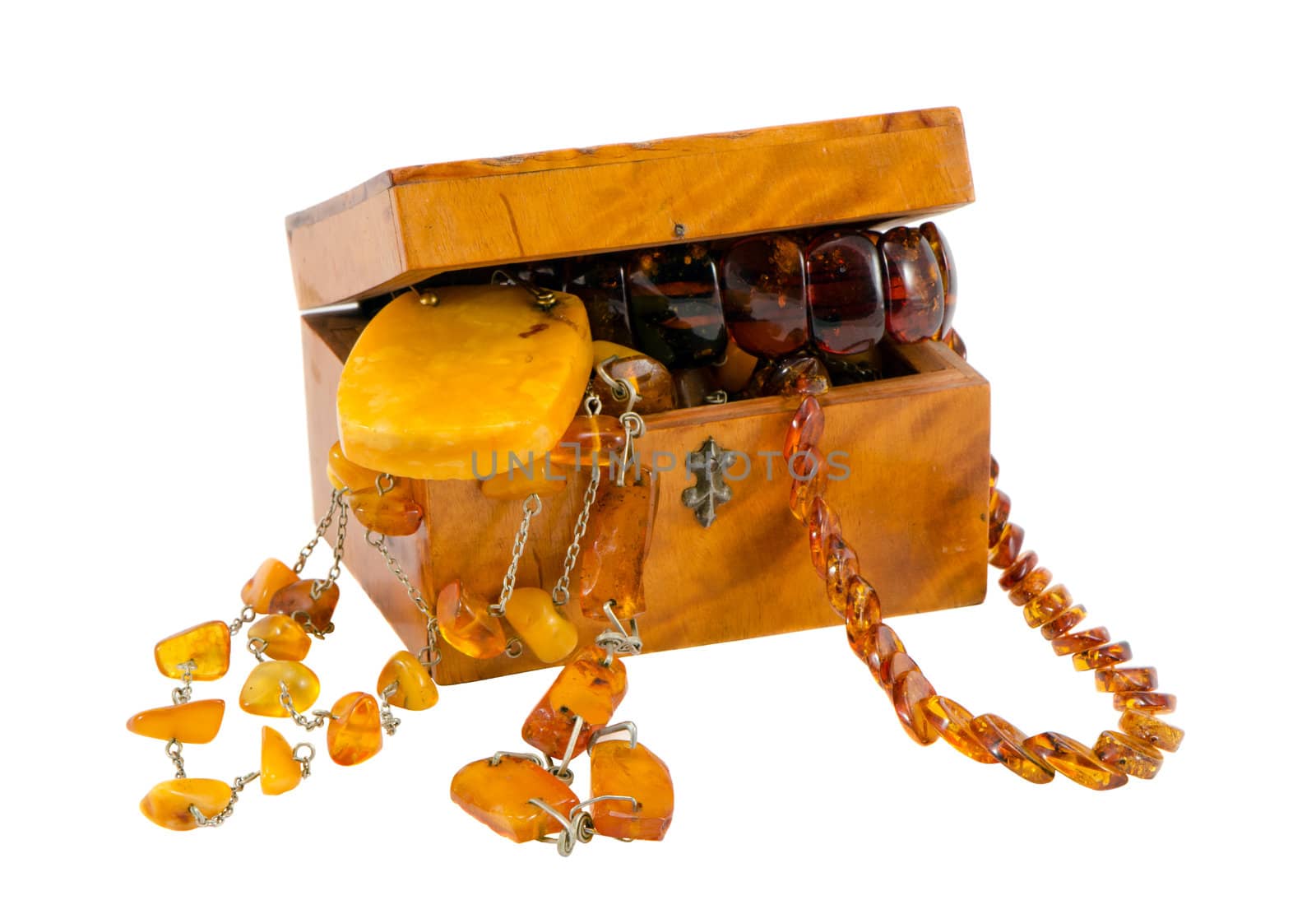 Amber jewelry in vintage wooden box chest isolated on white background