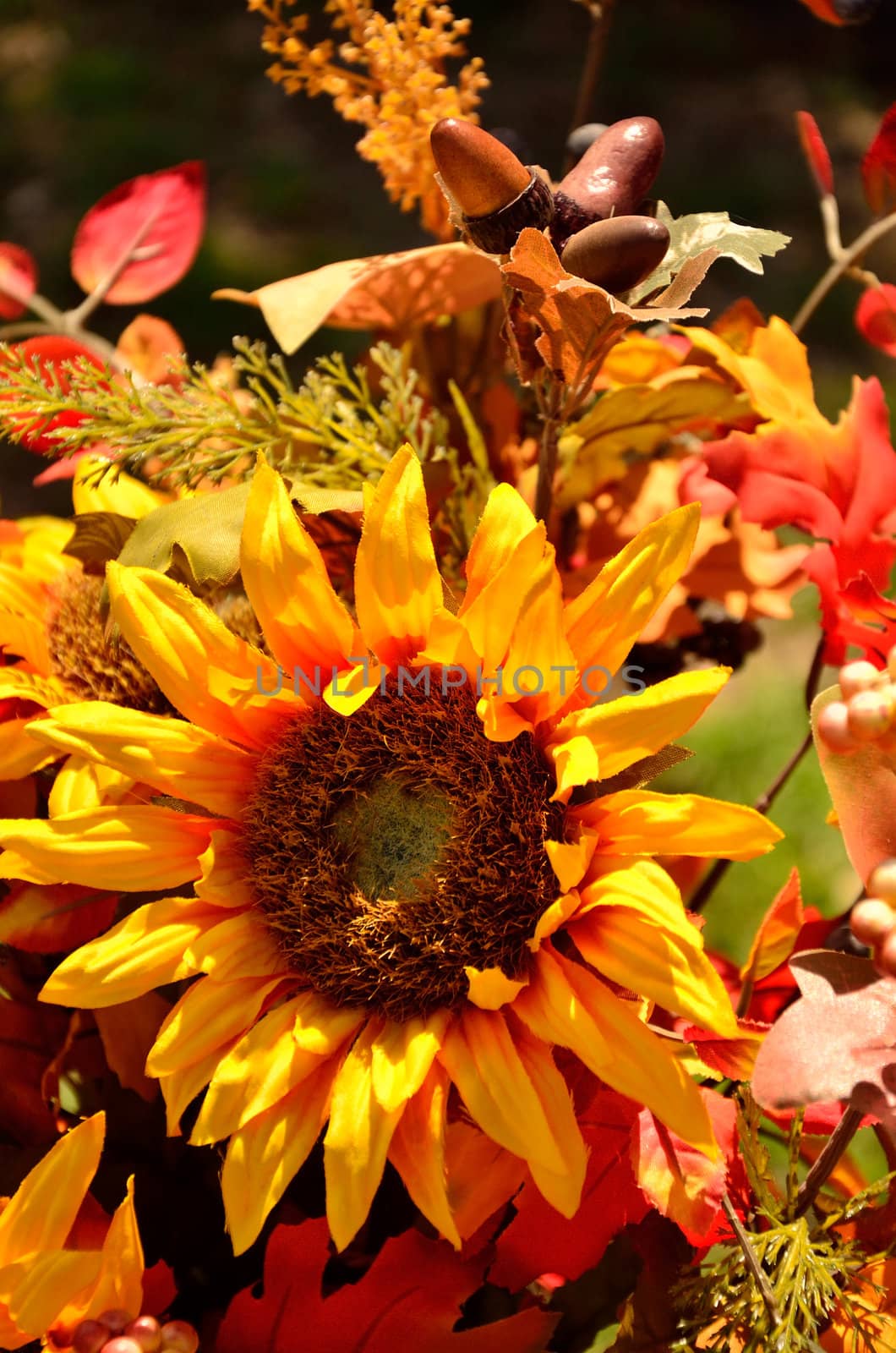 A yellow sunflower is the central piece of this fall arrangement