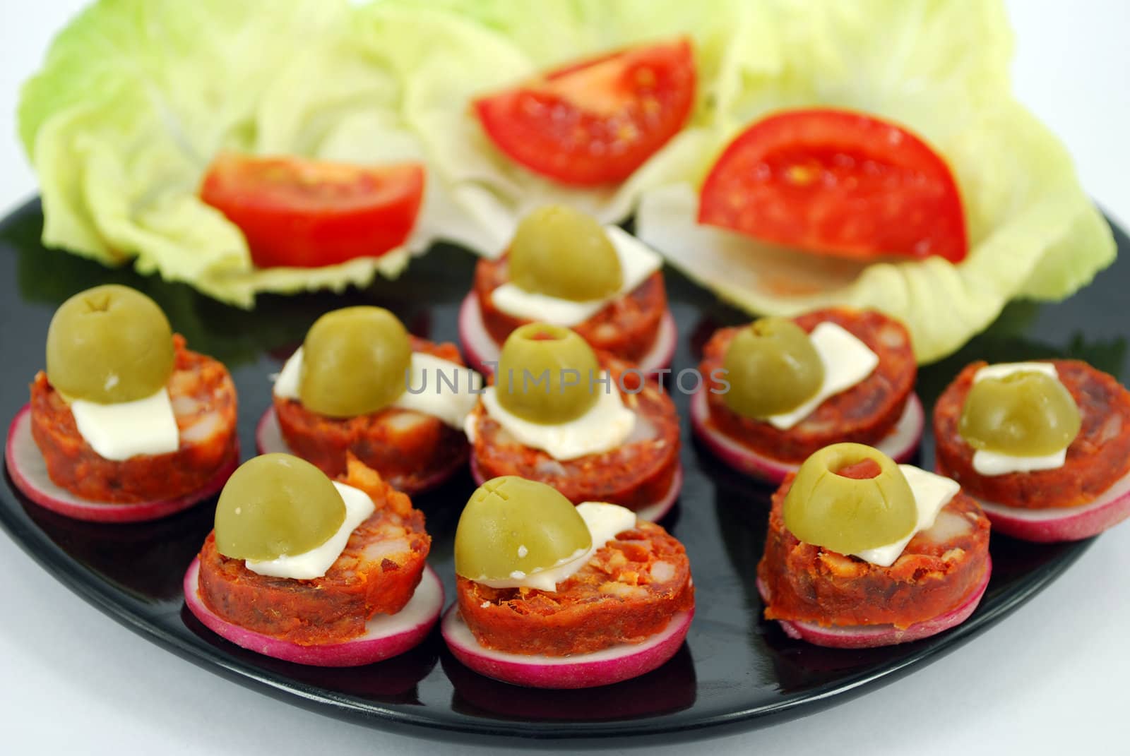 Delicatessen food with olives and salad