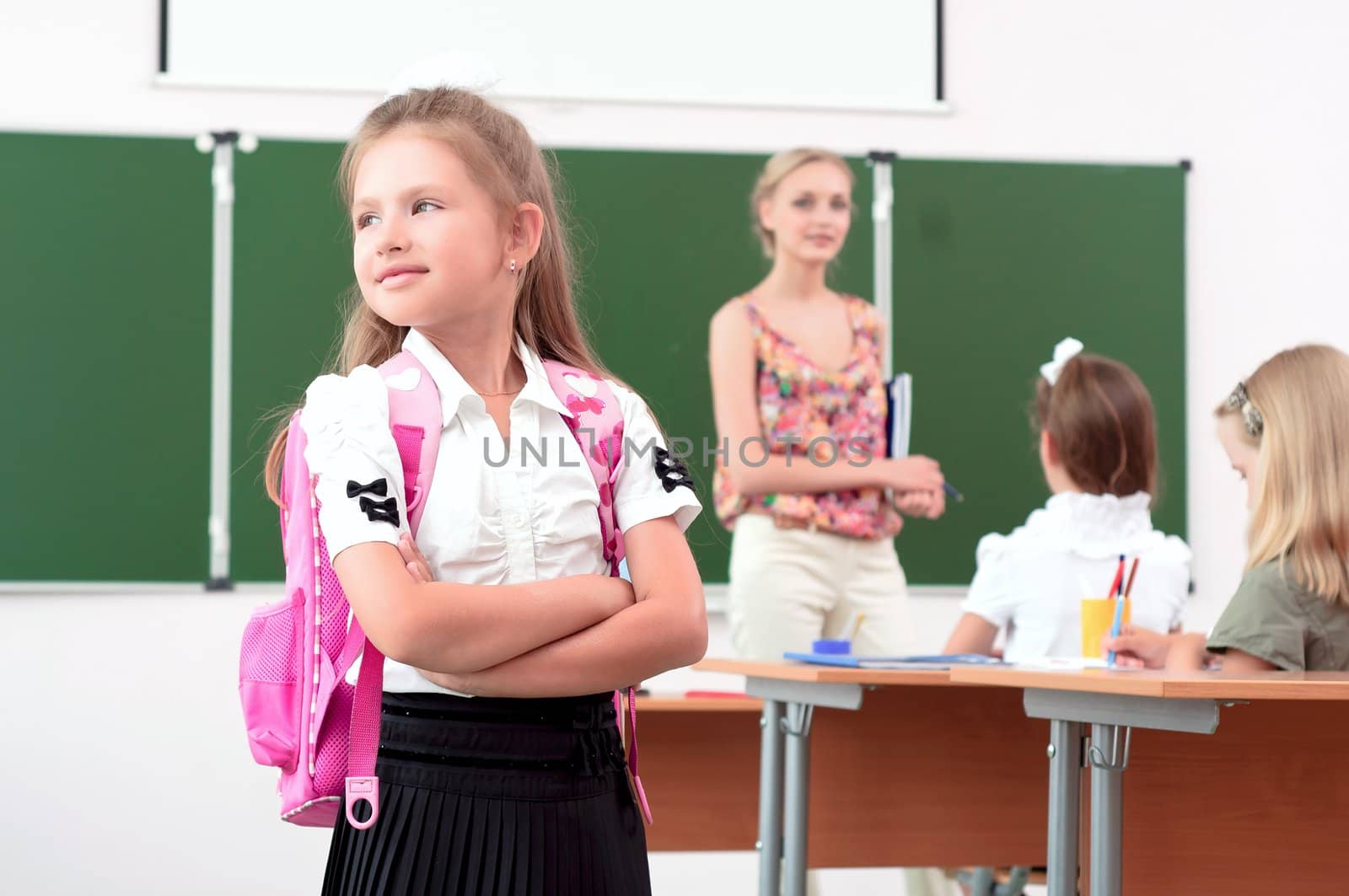 portrait of schoolgirl with a school backpack, looking out the window