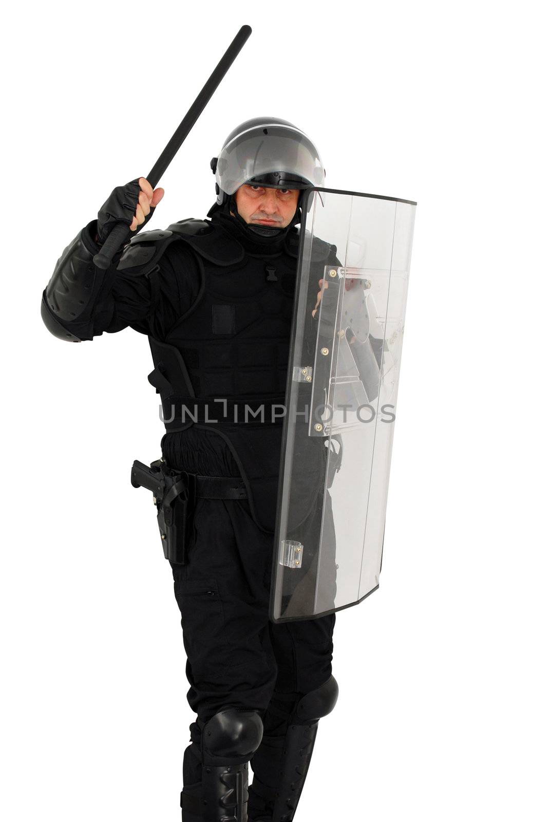 Riot policeman with nightstick and shield attacking isolated