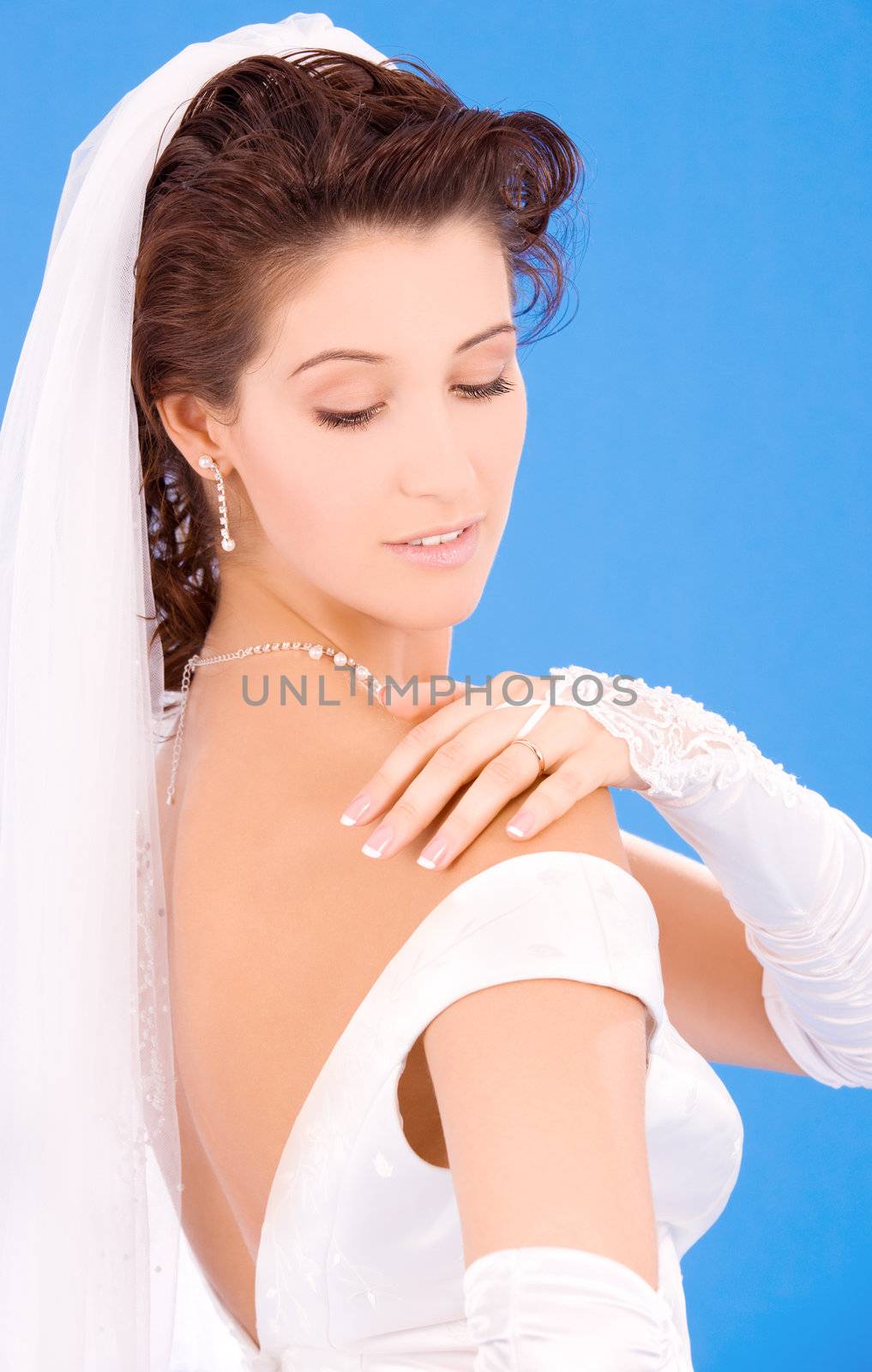 happy bride with her wedding ring over blue