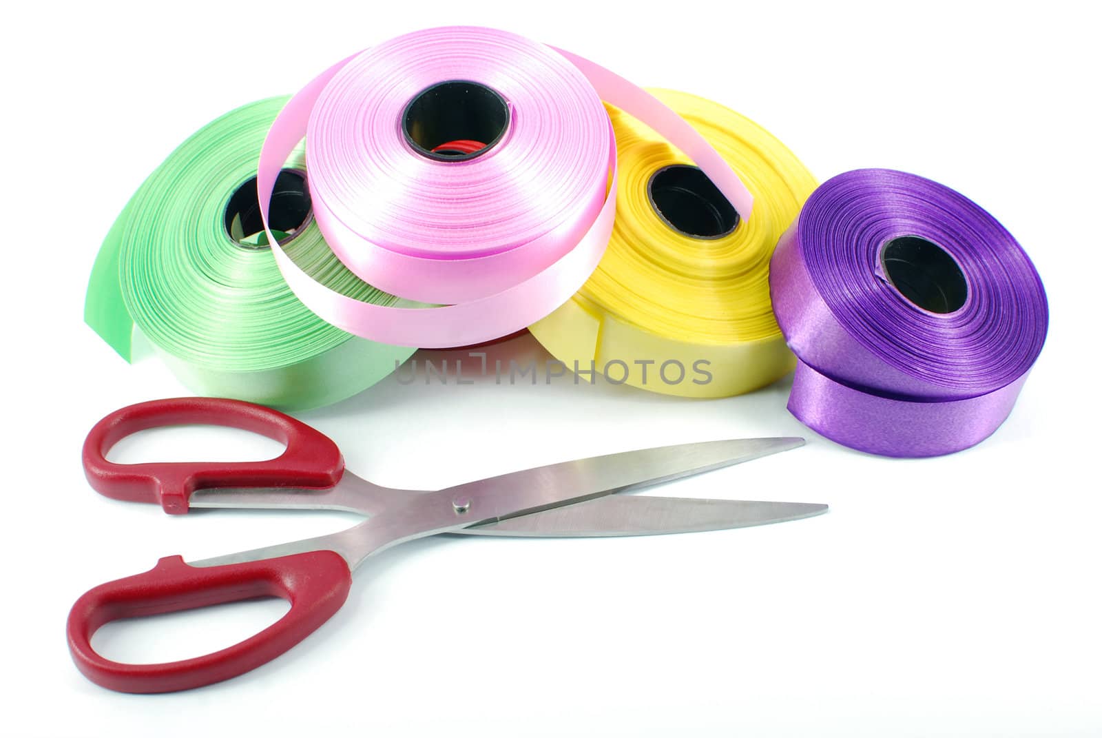Scissors and ribbons on white
