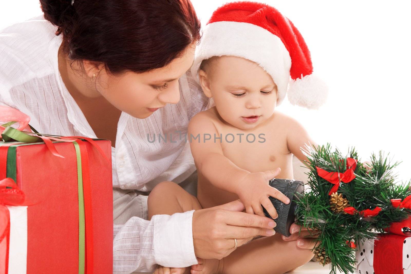 baby and mother with christmas gifts over white (focus on boy)