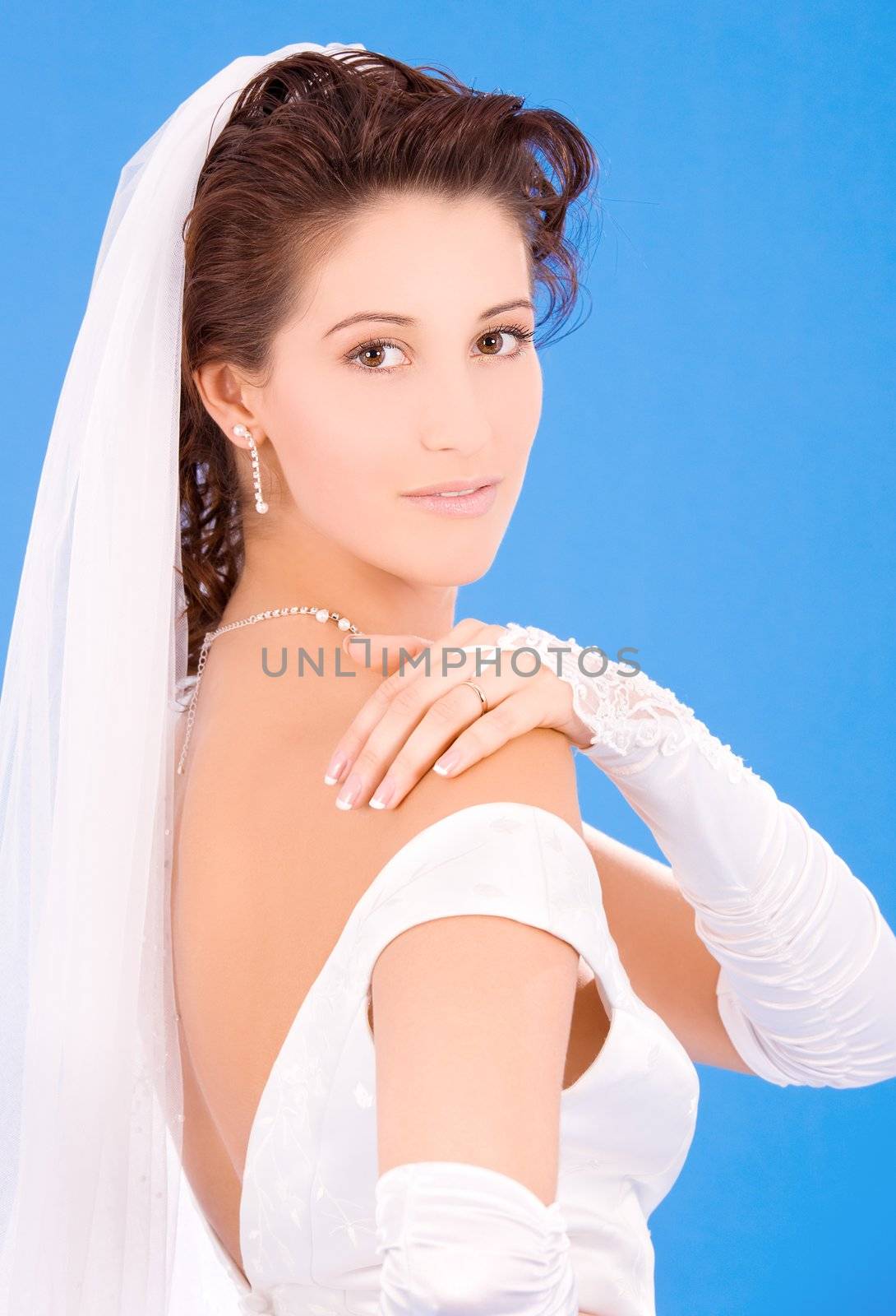 happy bride with her wedding ring over blue