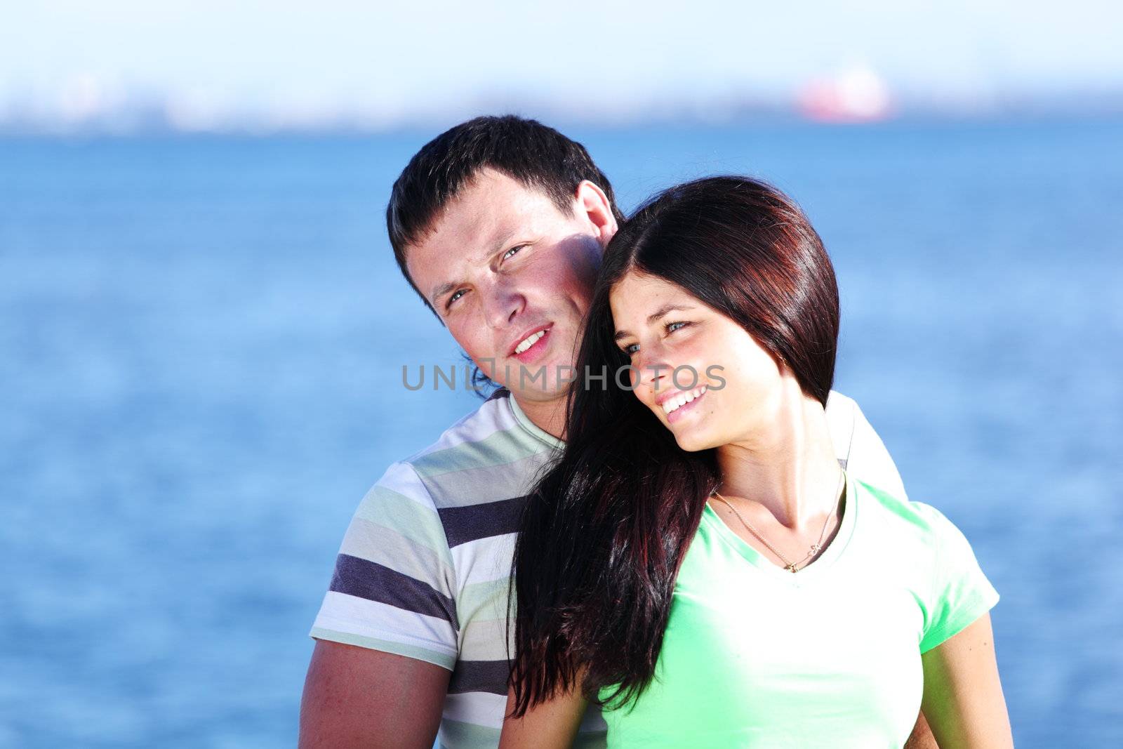 man and woman hug in the sky sea on background