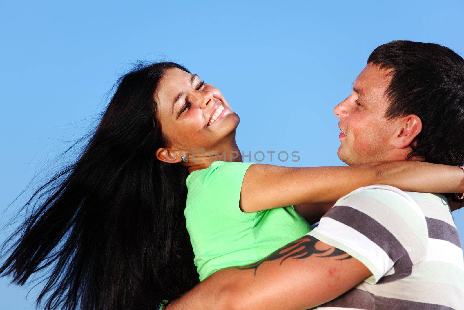 man and woman hug in the sky sea on background