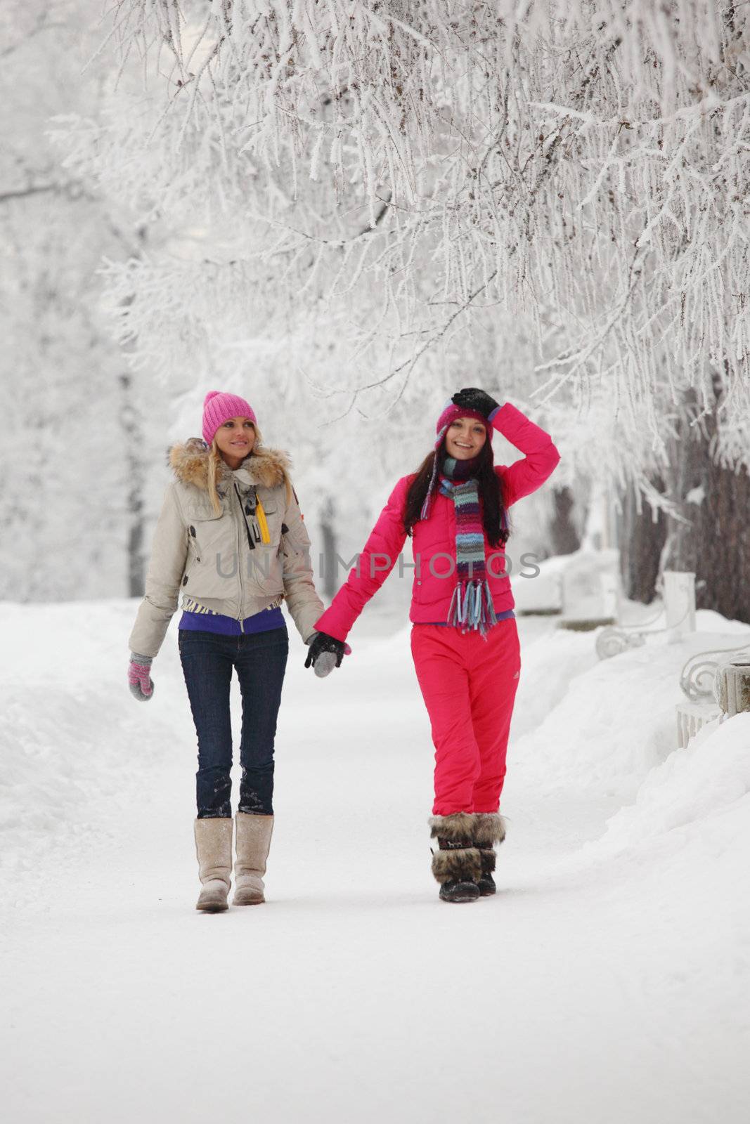 two winter women run by snow frosted alley