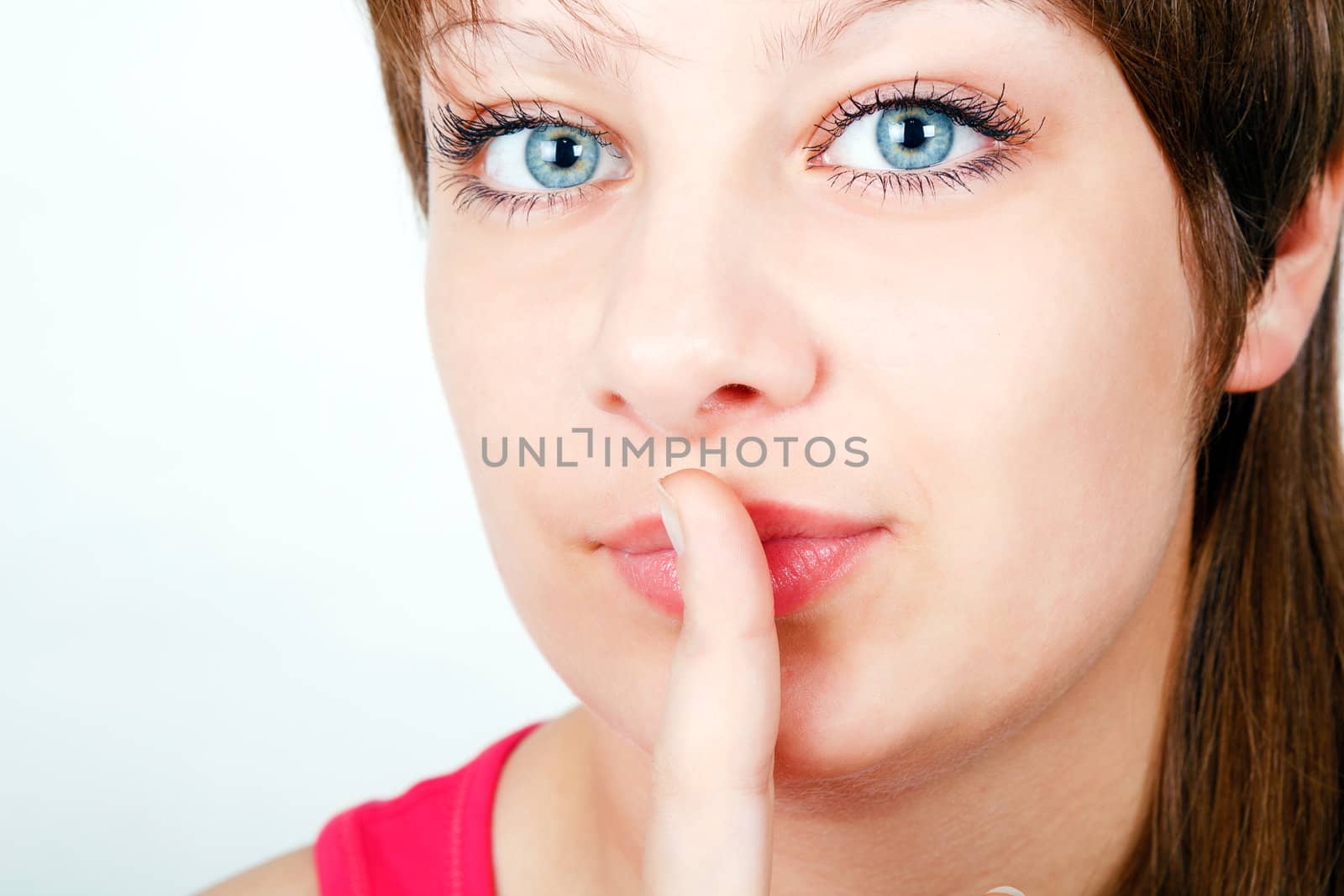 portrait of a girl put her finger to her lips