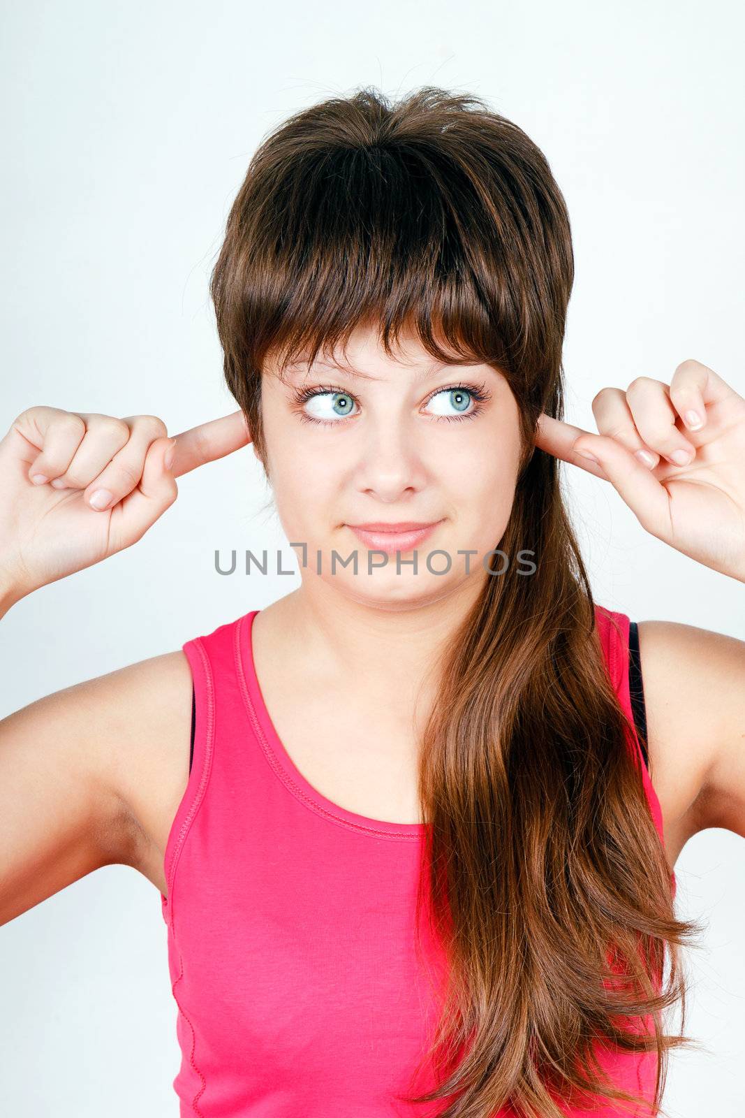 blue-eyed girl plugs fingers in his ears