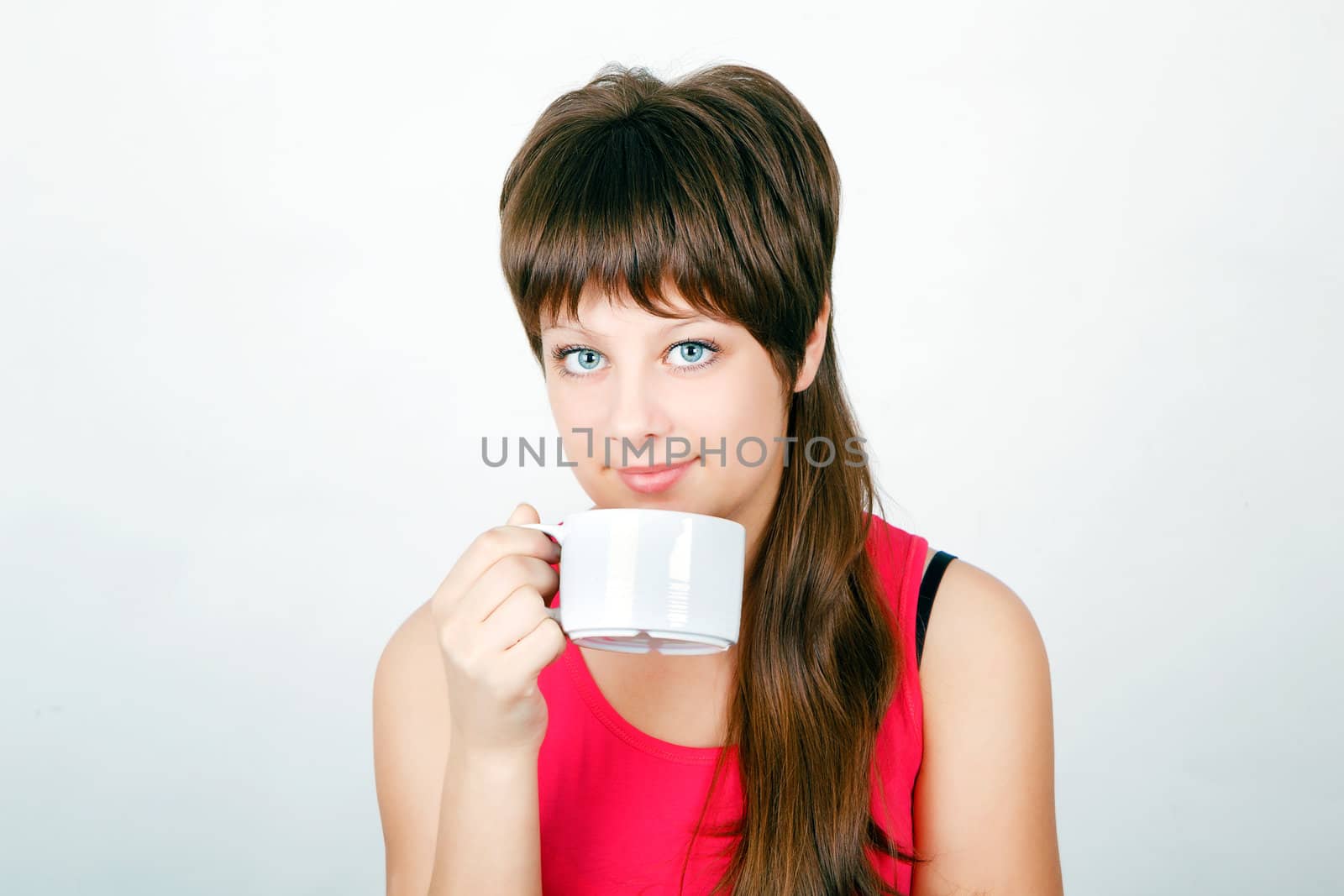 blue-eyed teen girl with a big white mug