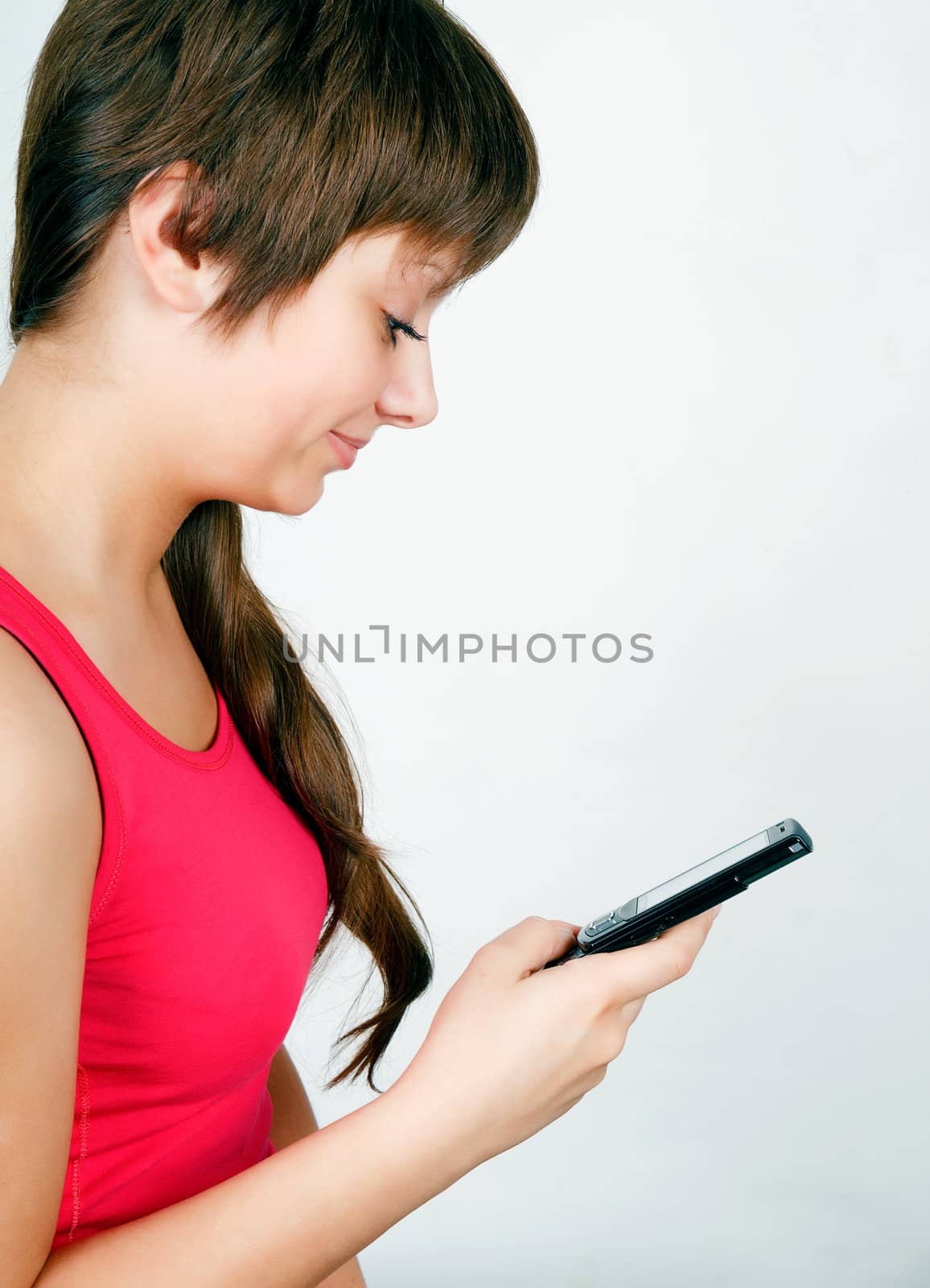 teen girl with a mobile phone reads the message